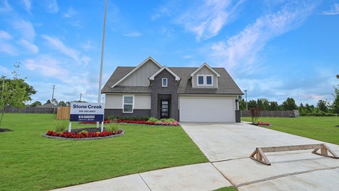 Exterior of one story brick home with two car garage