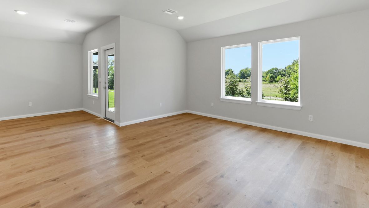 A well-organized living room that includes a kitchen and dining area, creating a warm and welcoming environment for gatherings.