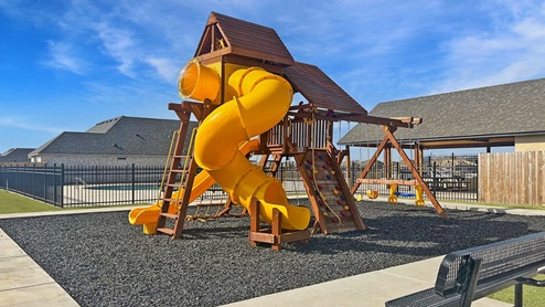 Exterior of community playground with spiral kids slide