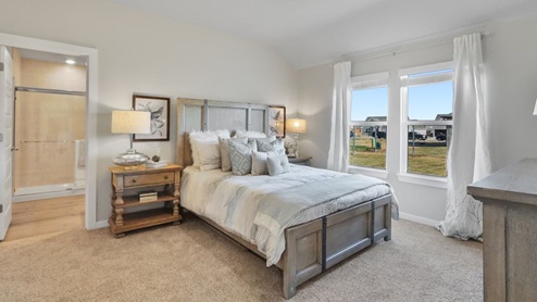 Interior bedroom with large windows and private bathroom
