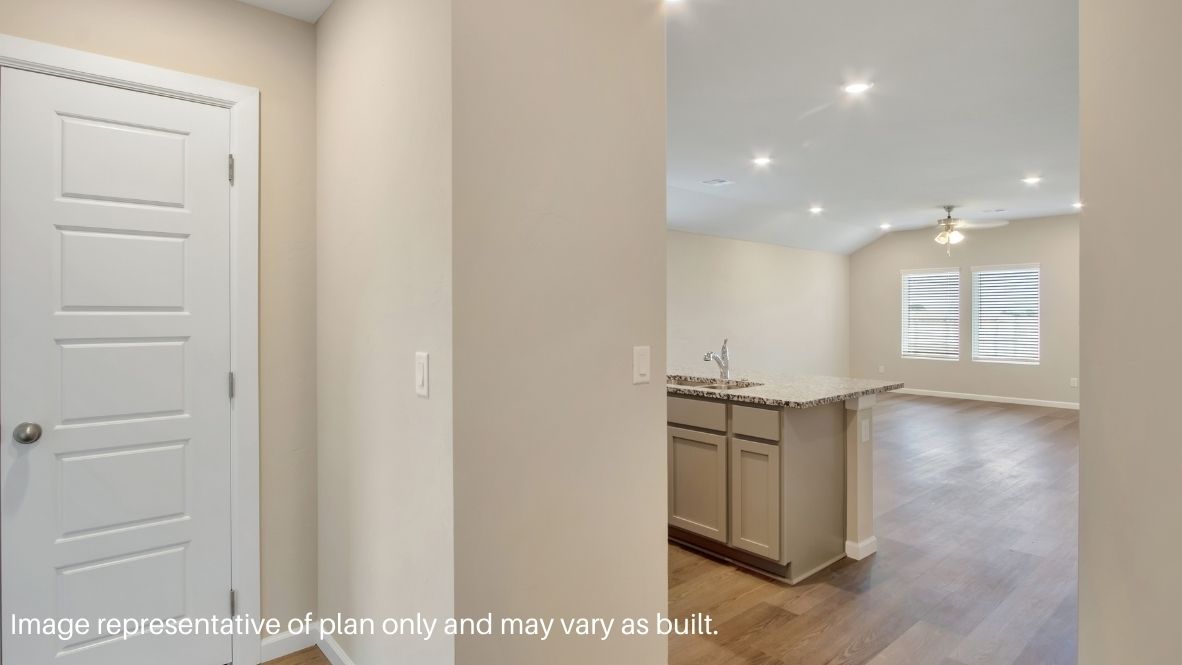 Entry hallway leading to living room and kitchen in the background.