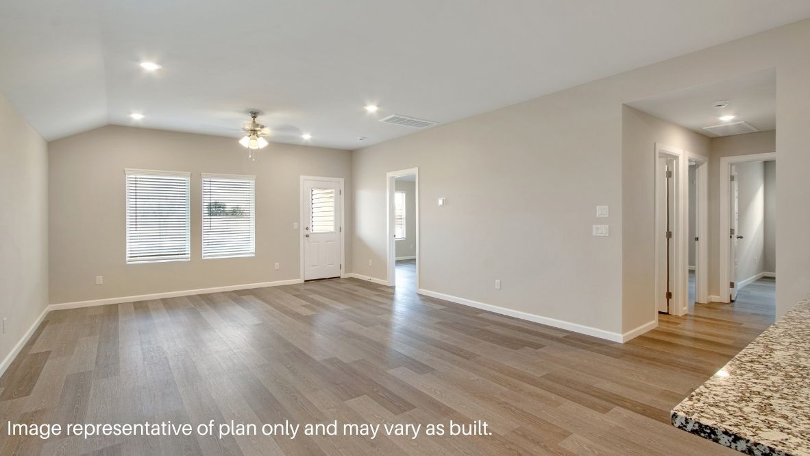 A well-organized living room that includes a kitchen and dining area, creating a warm and welcoming environment for gatherings.