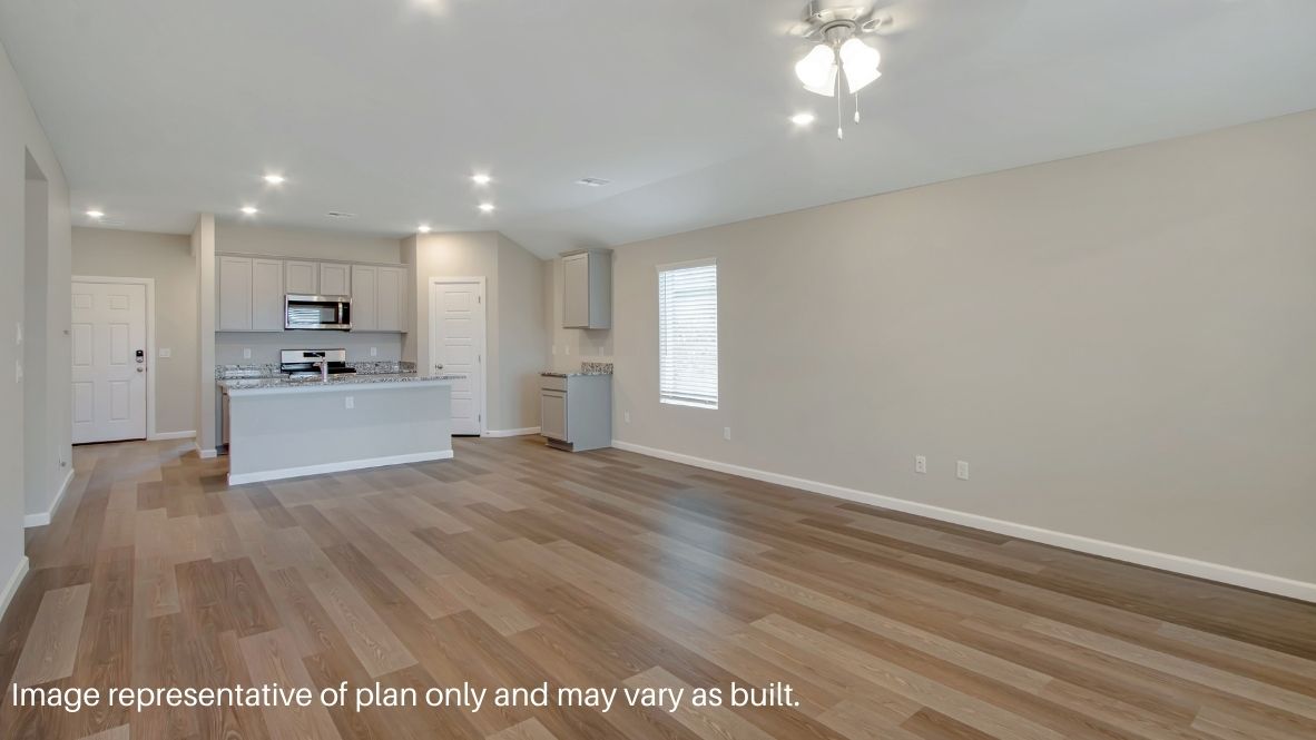 A well-organized living room that includes a kitchen and dining area, creating a warm and welcoming environment for gatherings.