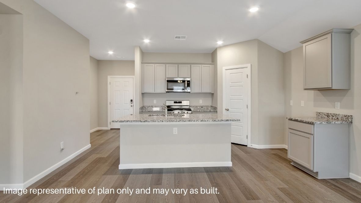 Contemporary kitchen adorned with white cabinets seamlessly integrated into an open dining area layout.