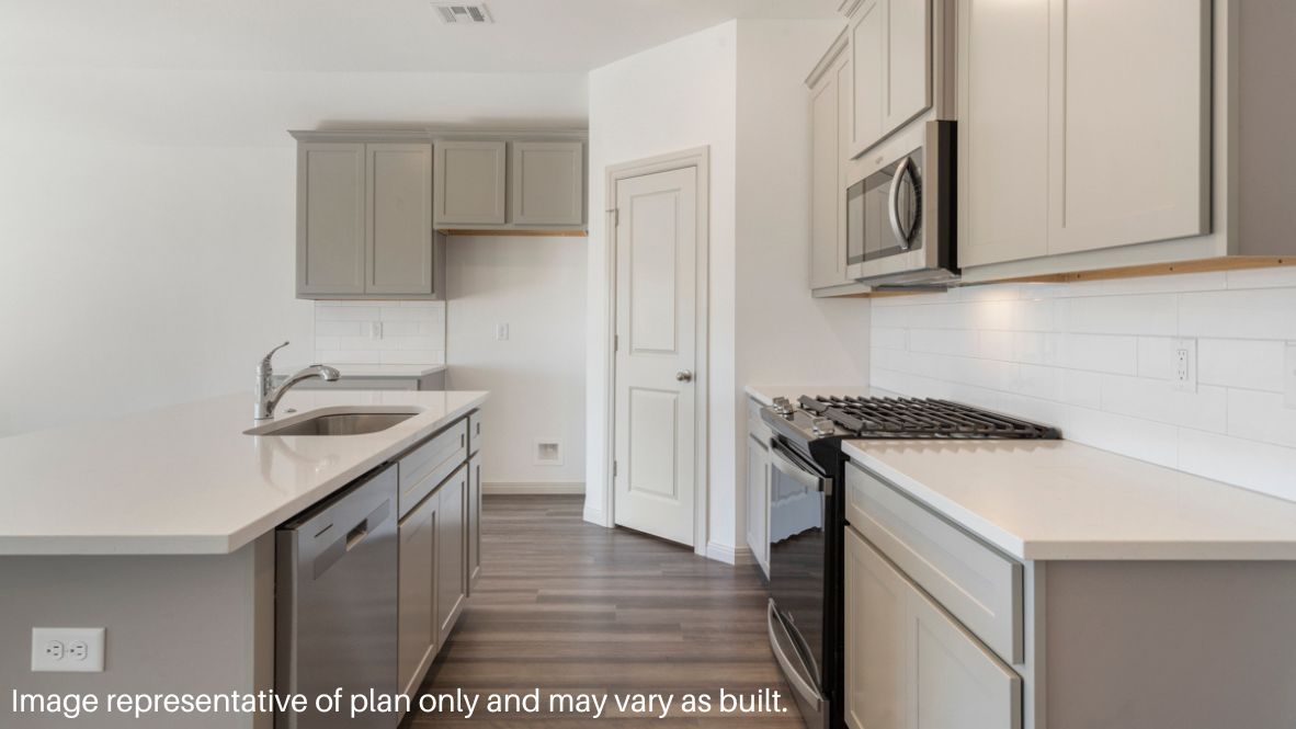 Bright and spacious kitchen with quartz countertops, stainless steel appliances, and an island with bar seating.