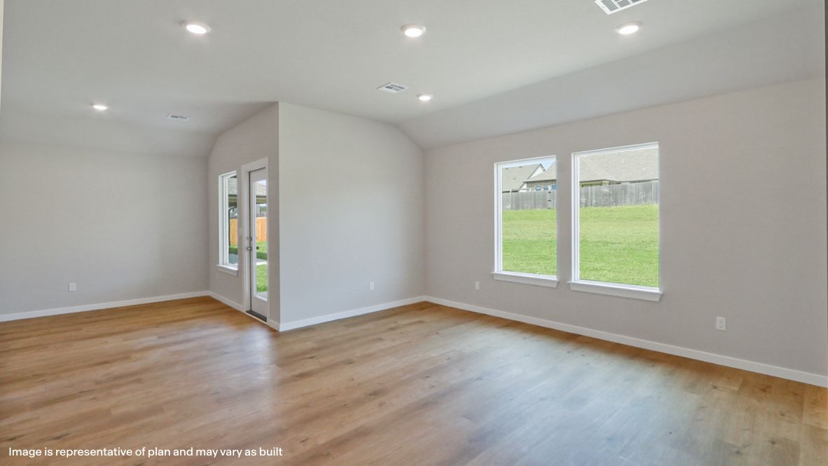 A well-organized living room that includes a kitchen and dining area, creating a warm and welcoming environment for gatherings.