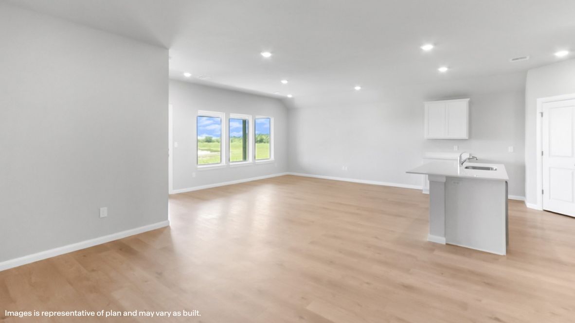 A well-organized living room that includes a kitchen and dining area, creating a warm and welcoming environment for gatherings.