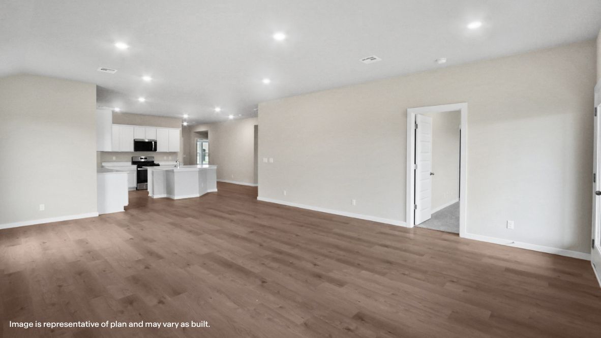 A well-organized living room that includes a kitchen and dining area, creating a warm and welcoming environment for gatherings.