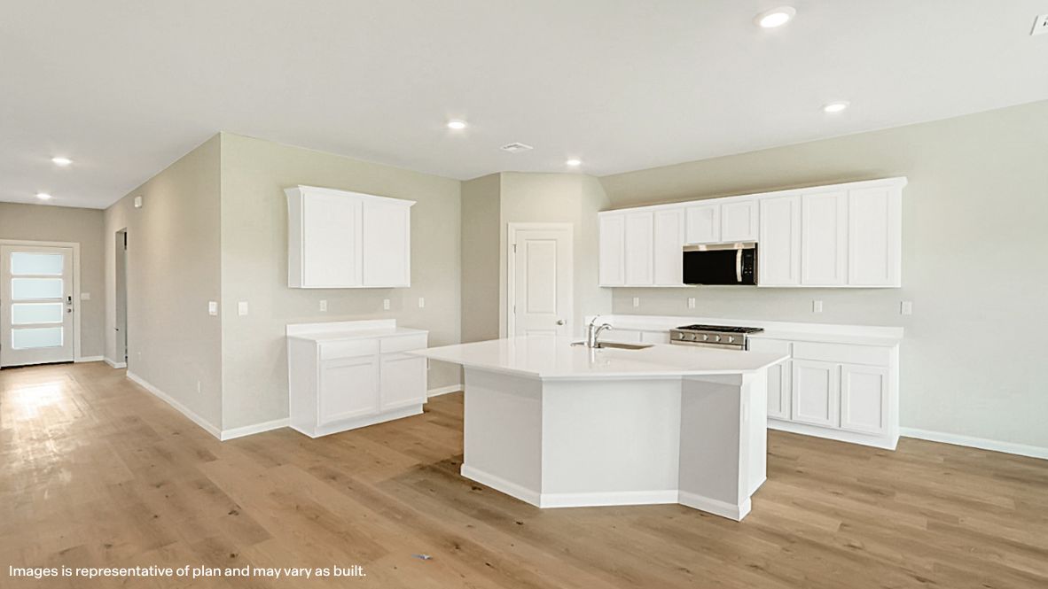 Contemporary kitchen adorned with white cabinets seamlessly integrated into an open dining area layout.