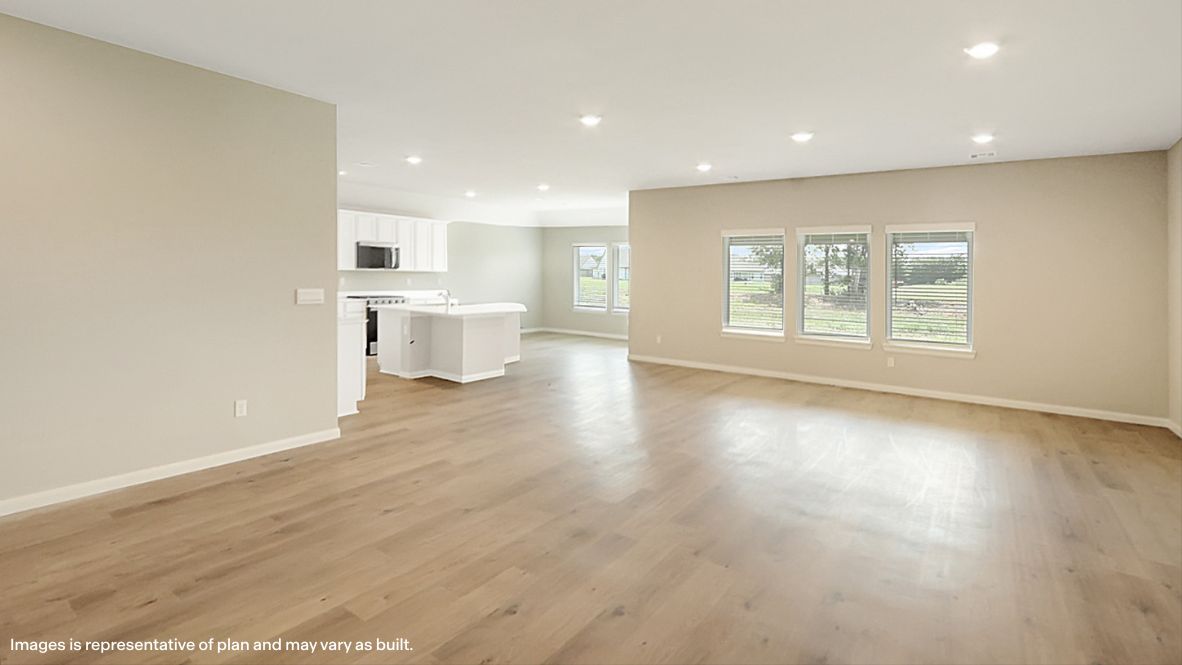 A well-organized living room that includes a kitchen and dining area, creating a warm and welcoming environment for gatherings.
