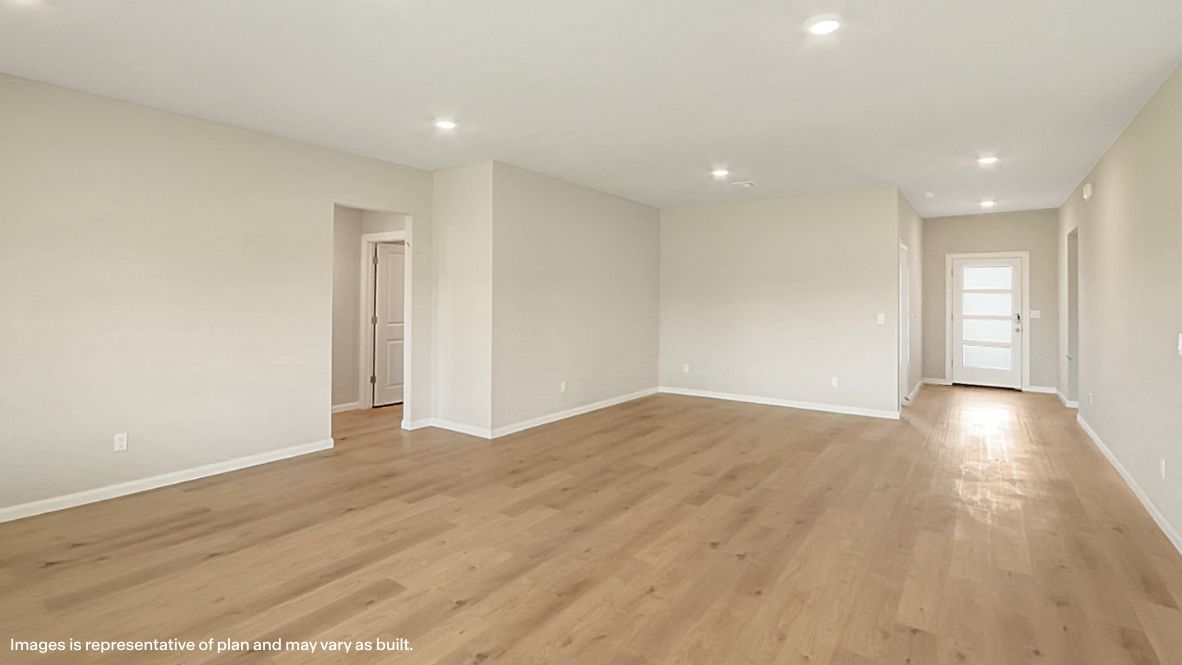A well-organized living room that includes a kitchen and dining area, creating a warm and welcoming environment for gatherings.