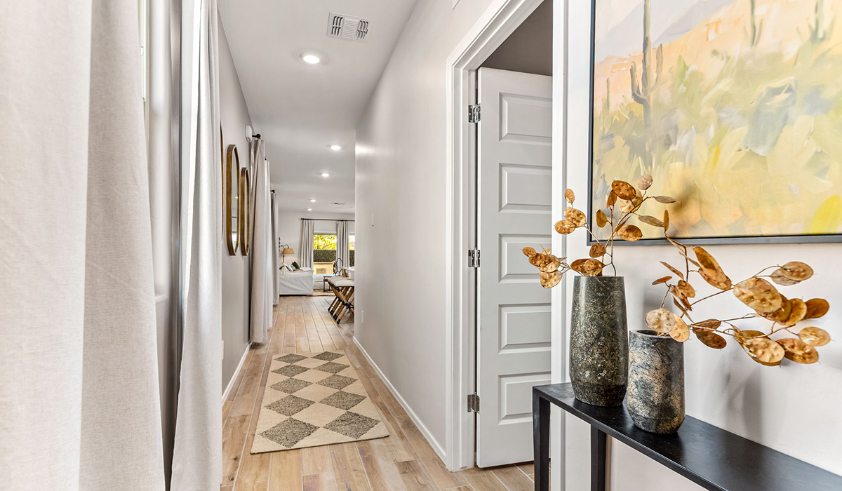 Discover new homes within the only gated community in Gladden Farms. Coronet at Gladden Farms, a premier D.R. Horton community where modern living meets the scenic charm of Marana, Arizona. Coronet offers residents the perfect blend of small-town warmth and modern amenities. Surrounded by 830 acres of green space, 28 parks, and 19 playgrounds, this gated community is designed for families who value both comfort and outdoor adventure.  Residents of Coronet at Gladden Farms enjoy exclusive amenities such as a sparkling community pool, jacuzzi, fitness center, and a clubhouse complete with a BBQ area and patio. The community also offers walking trails, a dog park, and playgrounds, making it the ideal environment for families and active lifestyles. Each home is thoughtfully designed with high-end finishes, including quartz countertops, wood-look luxury vinyl plank flooring, tile roofs, Spanish Lace stucco exteriors and beautifully landscaped front yards with auto drip irrigation. Additionally, all homes feature covered front porches and back patios, perfect for enjoying the stunning Arizona sunsets and monsoons.  Coronet at Gladden Farms is built with a commitment to energy efficiency and sustainability. Each home meets the DOE Zero Energy Ready Home standards, meaning they are constructed to be so energy-efficient that a renewable energy system could offset most or all of the home's annual energy use. These homes include advanced features such as tankless water heaters, energy-efficient LED lighting, and high-performance insulation, ensuring lower utility costs and a reduced environmental footprint. The Home is Connected Smart Home package, which includes a smart thermostat, video doorbell, keyless entry, a Wi-Fi-enabled garage door opener, and much more, provides modern convenience and enhanced security.  Living in Coronet at Gladden Farms means being part of a thriving community with easy access to shopping, dining, and recreation. The greater Gladden Farms area is equipped with amenities like a splashpad, soccer fields, and the Paws & Claws Dog Park. Families will appreciate being part of the Marana Unified School District, with Gladden Farms Elementary nearby and a new K-8 school opening in 2025.  Beyond the community, residents can explore the natural beauty of the area with proximity to Picacho Peak State Park, Tortolita Mountain Park, and Saguaro National Park, offering endless opportunities for hiking, cycling, and wildlife viewing. Experience the perfect blend of comfort, convenience, and community at Coronet at Gladden Farms—where new homes, energy efficiency, and a vibrant lifestyle await.