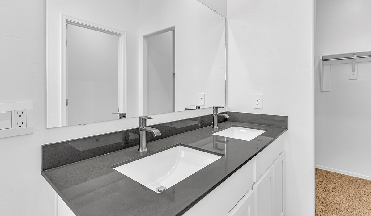 Welcome to The Amber at Coronet at Gladden Farms in Marana, Arizona – a thoughtfully designed 1,330 sq. ft. single-story new home that perfectly combines modern convenience with the natural beauty of the surrounding landscape.  As you step through the inviting front porch, you’re greeted by a smartly arranged entryway that opens into the heart of the home. The great room serves as the central gathering place, seamlessly connecting to the dining area and kitchen, creating an open and inviting space that’s perfect for both everyday living and entertaining.  The kitchen, designed with both style and functionality in mind, features quartz countertops, modern appliances, and a pantry that provides ample storage. The adjacent dining area offers a comfortable setting for meals, while the open layout ensures that the kitchen, dining, and living spaces are always connected.  At the rear of the home, the primary suite offers a peaceful retreat. The spacious bedroom leads to a well-appointed en-suite bathroom, complete with dual vanities, a walk-in shower, and a large walk-in closet, providing both comfort and convenience.  The Amber also includes two additional bedrooms, each offering plenty of space and natural light. These rooms are conveniently located near a second full bathroom, making them ideal for family members or guests.  Additional features of the home include a utility room and direct access to a two-car garage, adding practicality to the overall design. Step outside to the covered patio, where you can enjoy the stunning Arizona sunsets and the tranquil surroundings of Coronet at Gladden Farms.  Built with energy efficiency in mind, The Amber at Coronet at Gladden Farms is a DOE Zero Energy Ready Home, offering a sustainable lifestyle with lower utility costs and a reduced environmental footprint.  *Images shown are for reference only. They depict the home specifications and may not represent the actual home or design package.