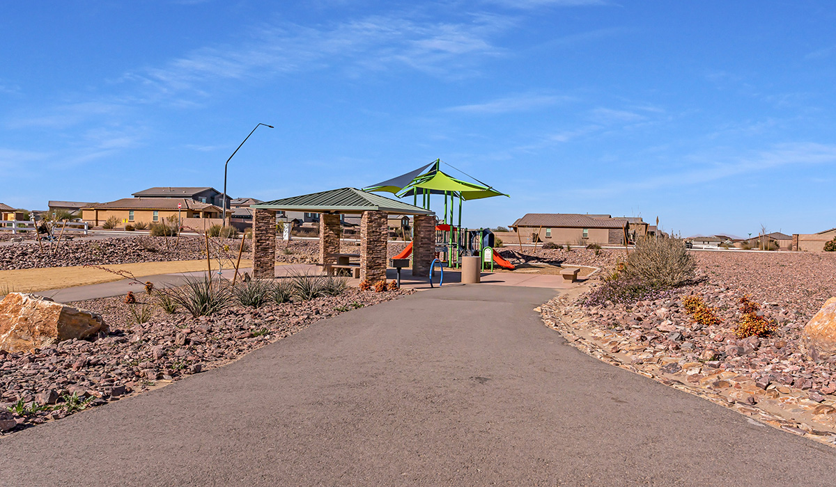 Welcome to The Amber at Coronet at Gladden Farms in Marana, Arizona – a thoughtfully designed 1,330 sq. ft. single-story new home that perfectly combines modern convenience with the natural beauty of the surrounding landscape.  As you step through the inviting front porch, you’re greeted by a smartly arranged entryway that opens into the heart of the home. The great room serves as the central gathering place, seamlessly connecting to the dining area and kitchen, creating an open and inviting space that’s perfect for both everyday living and entertaining.  The kitchen, designed with both style and functionality in mind, features quartz countertops, modern appliances, and a pantry that provides ample storage. The adjacent dining area offers a comfortable setting for meals, while the open layout ensures that the kitchen, dining, and living spaces are always connected.  At the rear of the home, the primary suite offers a peaceful retreat. The spacious bedroom leads to a well-appointed en-suite bathroom, complete with dual vanities, a walk-in shower, and a large walk-in closet, providing both comfort and convenience.  The Amber also includes two additional bedrooms, each offering plenty of space and natural light. These rooms are conveniently located near a second full bathroom, making them ideal for family members or guests.  Additional features of the home include a utility room and direct access to a two-car garage, adding practicality to the overall design. Step outside to the covered patio, where you can enjoy the stunning Arizona sunsets and the tranquil surroundings of Coronet at Gladden Farms.  Built with energy efficiency in mind, The Amber at Coronet at Gladden Farms is a DOE Zero Energy Ready Home, offering a sustainable lifestyle with lower utility costs and a reduced environmental footprint.  *Images shown are for reference only. They depict the home specifications and may not represent the actual home or design package.