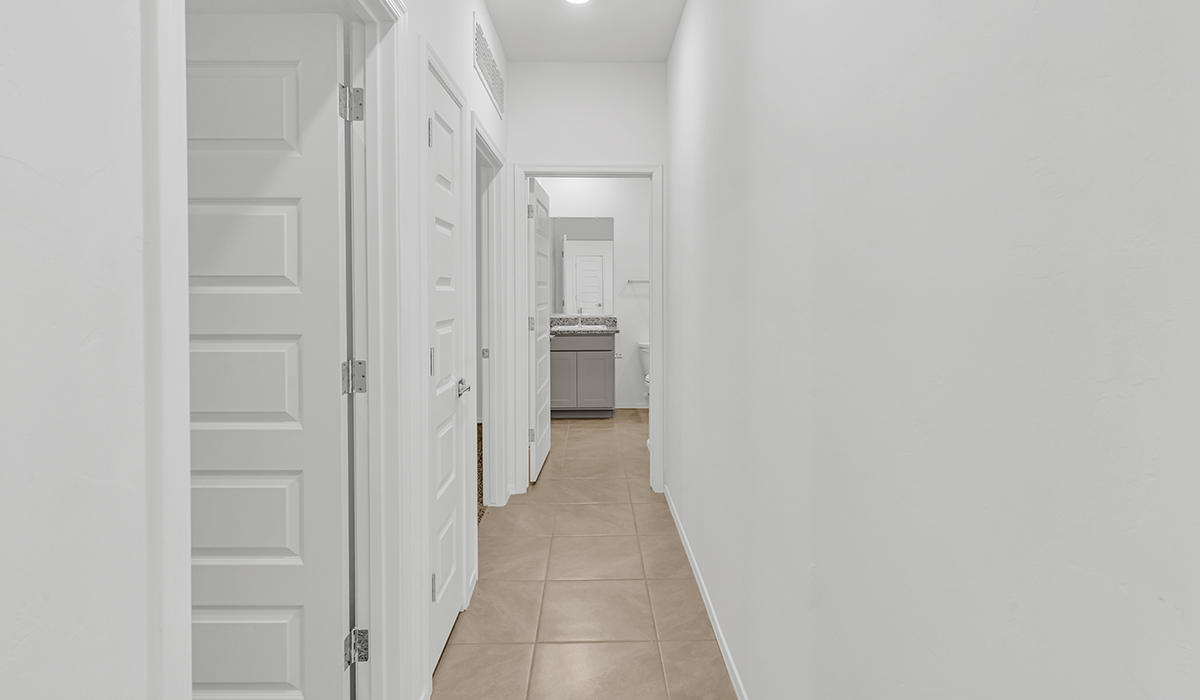 Welcome to The Amber at Coronet at Gladden Farms in Marana, Arizona – a thoughtfully designed 1,330 sq. ft. single-story new home that perfectly combines modern convenience with the natural beauty of the surrounding landscape.  As you step through the inviting front porch, you’re greeted by a smartly arranged entryway that opens into the heart of the home. The great room serves as the central gathering place, seamlessly connecting to the dining area and kitchen, creating an open and inviting space that’s perfect for both everyday living and entertaining.  The kitchen, designed with both style and functionality in mind, features quartz countertops, modern appliances, and a pantry that provides ample storage. The adjacent dining area offers a comfortable setting for meals, while the open layout ensures that the kitchen, dining, and living spaces are always connected.  At the rear of the home, the primary suite offers a peaceful retreat. The spacious bedroom leads to a well-appointed en-suite bathroom, complete with dual vanities, a walk-in shower, and a large walk-in closet, providing both comfort and convenience.  The Amber also includes two additional bedrooms, each offering plenty of space and natural light. These rooms are conveniently located near a second full bathroom, making them ideal for family members or guests.  Additional features of the home include a utility room and direct access to a two-car garage, adding practicality to the overall design. Step outside to the covered patio, where you can enjoy the stunning Arizona sunsets and the tranquil surroundings of Coronet at Gladden Farms.  Built with energy efficiency in mind, The Amber at Coronet at Gladden Farms is a DOE Zero Energy Ready Home, offering a sustainable lifestyle with lower utility costs and a reduced environmental footprint.