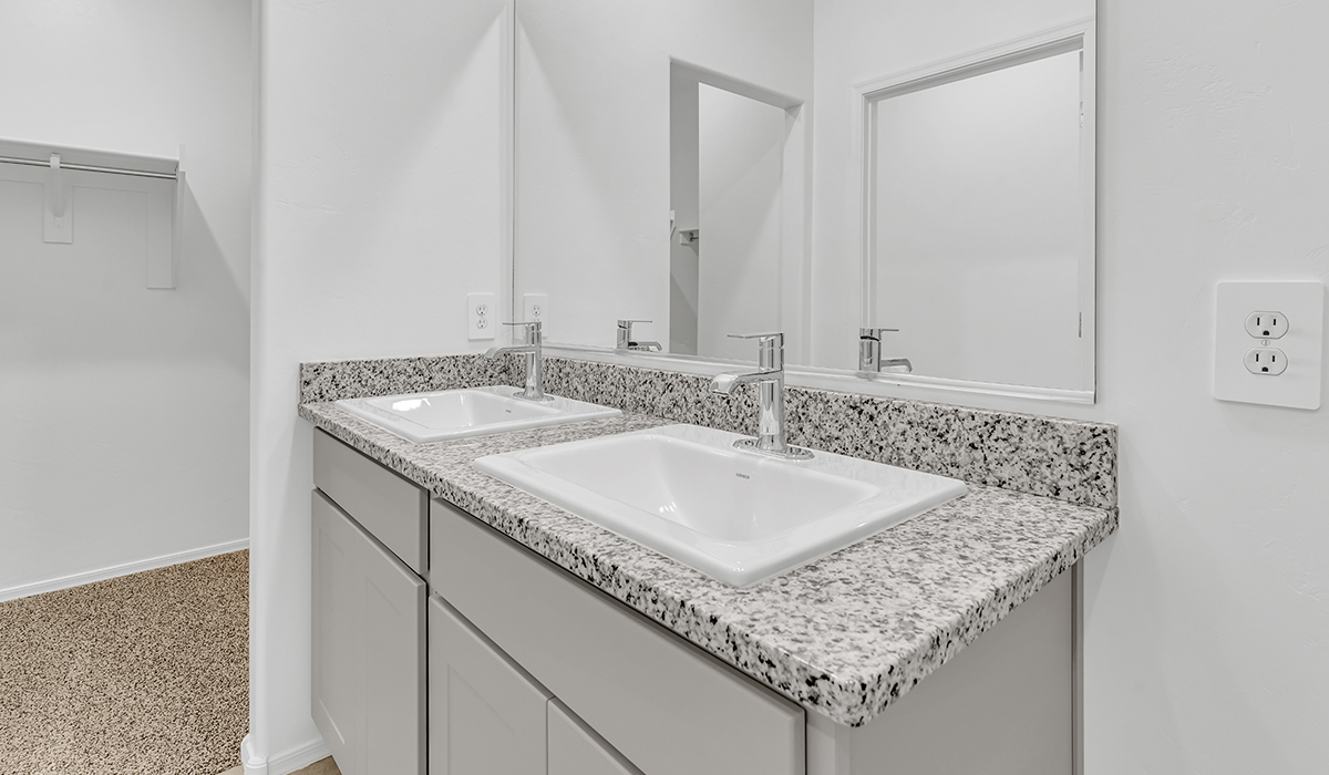 Welcome to The Amber at Coronet at Gladden Farms in Marana, Arizona – a thoughtfully designed 1,330 sq. ft. single-story new home that perfectly combines modern convenience with the natural beauty of the surrounding landscape.  As you step through the inviting front porch, you’re greeted by a smartly arranged entryway that opens into the heart of the home. The great room serves as the central gathering place, seamlessly connecting to the dining area and kitchen, creating an open and inviting space that’s perfect for both everyday living and entertaining.  The kitchen, designed with both style and functionality in mind, features quartz countertops, modern appliances, and a pantry that provides ample storage. The adjacent dining area offers a comfortable setting for meals, while the open layout ensures that the kitchen, dining, and living spaces are always connected.  At the rear of the home, the primary suite offers a peaceful retreat. The spacious bedroom leads to a well-appointed en-suite bathroom, complete with dual vanities, a walk-in shower, and a large walk-in closet, providing both comfort and convenience.  The Amber also includes two additional bedrooms, each offering plenty of space and natural light. These rooms are conveniently located near a second full bathroom, making them ideal for family members or guests.  Additional features of the home include a utility room and direct access to a two-car garage, adding practicality to the overall design. Step outside to the covered patio, where you can enjoy the stunning Arizona sunsets and the tranquil surroundings of Coronet at Gladden Farms.  Built with energy efficiency in mind, The Amber at Coronet at Gladden Farms is a DOE Zero Energy Ready Home, offering a sustainable lifestyle with lower utility costs and a reduced environmental footprint.