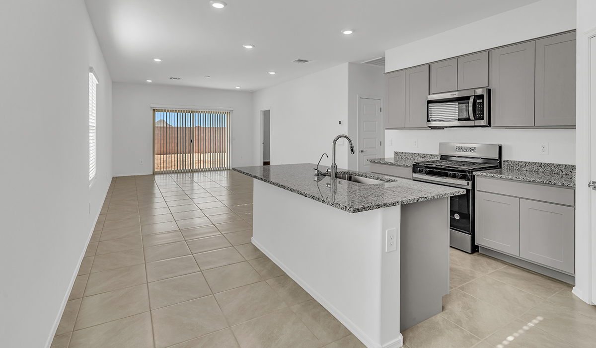 Welcome to The Amber at Coronet at Gladden Farms in Marana, Arizona – a thoughtfully designed 1,330 sq. ft. single-story new home that perfectly combines modern convenience with the natural beauty of the surrounding landscape.  As you step through the inviting front porch, you’re greeted by a smartly arranged entryway that opens into the heart of the home. The great room serves as the central gathering place, seamlessly connecting to the dining area and kitchen, creating an open and inviting space that’s perfect for both everyday living and entertaining.  The kitchen, designed with both style and functionality in mind, features quartz countertops, modern appliances, and a pantry that provides ample storage. The adjacent dining area offers a comfortable setting for meals, while the open layout ensures that the kitchen, dining, and living spaces are always connected.  At the rear of the home, the primary suite offers a peaceful retreat. The spacious bedroom leads to a well-appointed en-suite bathroom, complete with dual vanities, a walk-in shower, and a large walk-in closet, providing both comfort and convenience.  The Amber also includes two additional bedrooms, each offering plenty of space and natural light. These rooms are conveniently located near a second full bathroom, making them ideal for family members or guests.  Additional features of the home include a utility room and direct access to a two-car garage, adding practicality to the overall design. Step outside to the covered patio, where you can enjoy the stunning Arizona sunsets and the tranquil surroundings of Coronet at Gladden Farms.  Built with energy efficiency in mind, The Amber at Coronet at Gladden Farms is a DOE Zero Energy Ready Home, offering a sustainable lifestyle with lower utility costs and a reduced environmental footprint.