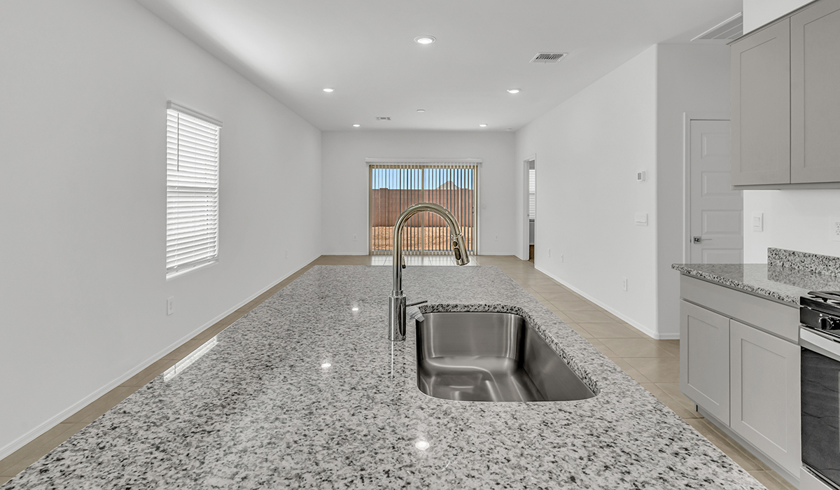 Welcome to The Amber at Coronet at Gladden Farms in Marana, Arizona – a thoughtfully designed 1,330 sq. ft. single-story new home that perfectly combines modern convenience with the natural beauty of the surrounding landscape.  As you step through the inviting front porch, you’re greeted by a smartly arranged entryway that opens into the heart of the home. The great room serves as the central gathering place, seamlessly connecting to the dining area and kitchen, creating an open and inviting space that’s perfect for both everyday living and entertaining.  The kitchen, designed with both style and functionality in mind, features quartz countertops, modern appliances, and a pantry that provides ample storage. The adjacent dining area offers a comfortable setting for meals, while the open layout ensures that the kitchen, dining, and living spaces are always connected.  At the rear of the home, the primary suite offers a peaceful retreat. The spacious bedroom leads to a well-appointed en-suite bathroom, complete with dual vanities, a walk-in shower, and a large walk-in closet, providing both comfort and convenience.  The Amber also includes two additional bedrooms, each offering plenty of space and natural light. These rooms are conveniently located near a second full bathroom, making them ideal for family members or guests.  Additional features of the home include a utility room and direct access to a two-car garage, adding practicality to the overall design. Step outside to the covered patio, where you can enjoy the stunning Arizona sunsets and the tranquil surroundings of Coronet at Gladden Farms.  Built with energy efficiency in mind, The Amber at Coronet at Gladden Farms is a DOE Zero Energy Ready Home, offering a sustainable lifestyle with lower utility costs and a reduced environmental footprint.