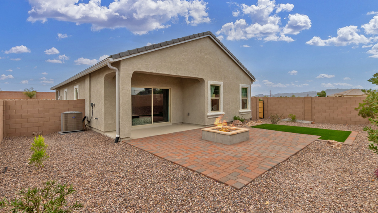 Welcome to The Amber at Coronet at Gladden Farms in Marana, Arizona – a thoughtfully designed 1,330 sq. ft. single-story new home that perfectly combines modern convenience with the natural beauty of the surrounding landscape.  As you step through the inviting front porch, you’re greeted by a smartly arranged entryway that opens into the heart of the home. The great room serves as the central gathering place, seamlessly connecting to the dining area and kitchen, creating an open and inviting space that’s perfect for both everyday living and entertaining.  The kitchen, designed with both style and functionality in mind, features quartz countertops, modern appliances, and a pantry that provides ample storage. The adjacent dining area offers a comfortable setting for meals, while the open layout ensures that the kitchen, dining, and living spaces are always connected.  At the rear of the home, the master suite offers a peaceful retreat. The spacious bedroom leads to a well-appointed en-suite bathroom, complete with dual vanities, a walk-in shower, and a large walk-in closet, providing both comfort and convenience.  The Amber also includes two additional bedrooms, each offering plenty of space and natural light. These rooms are conveniently located near a second full bathroom, making them ideal for family members or guests.  Additional features of the home include a utility room and direct access to a two-car garage, adding practicality to the overall design. Step outside to the covered patio, where you can enjoy the stunning Arizona sunsets and the tranquil surroundings of Coronet at Gladden Farms.  Built with energy efficiency in mind, The Amber at Coronet at Gladden Farms is a DOE Zero Energy Ready Home, offering a sustainable lifestyle with lower utility costs and a reduced environmental footprint.