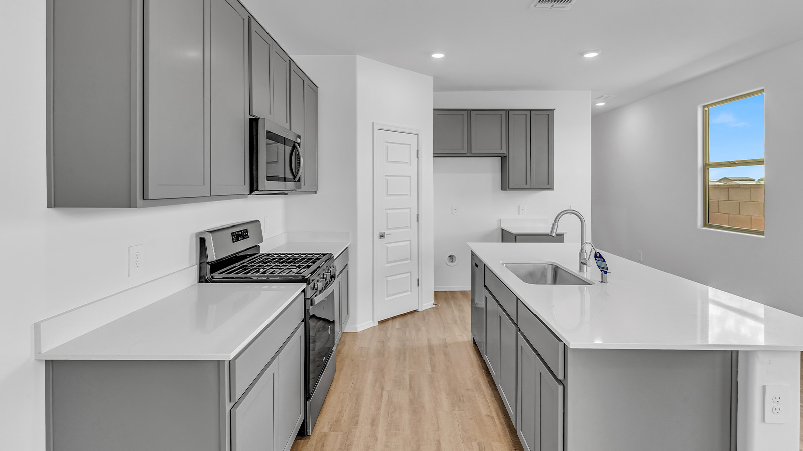 Introducing The Brooke at Coronet at Gladden Farms in Marana, Arizona – a unique 1,654 sq. ft. single-story new home designed for those who seek both comfort and style in a picturesque setting. Exclusively available at Coronet at Gladden Farms, this floorplan offers a one-of-a-kind living experience you won’t find anywhere else.  As you enter through the welcoming front porch, you’ll find yourself in a well-designed entryway that leads into the heart of the home. The great room, with its open and airy layout, is the perfect spot for gathering with family and friends. It flows seamlessly into the dining area and kitchen, creating an inviting space that’s ideal for everything from casual meals to entertaining guests.  The kitchen is the centerpiece of this home, featuring quartz countertops, modern appliances, and a large pantry that provides ample storage. The adjacent dining area offers a comfortable setting for meals, and the open-concept design ensures that the kitchen, dining, and living spaces are always connected.  The Brooke offers a well-thought-out floor plan with four bedrooms, making it perfect for families of all sizes. The master suite, located at the rear of the home, provides a private retreat with a spacious bedroom, a walk-in closet, and an en-suite bathroom complete with dual vanities and a walk-in shower. The additional three bedrooms are thoughtfully positioned near the second full bathroom, ensuring comfort and convenience for all.  A utility room and a two-car garage add practicality to the overall design, while the covered patio extends your living space outdoors. Here, you can enjoy Arizona’s beautiful weather and the stunning views that Coronet at Gladden Farms has to offer.  Designed with energy efficiency in mind, The Brooke at Coronet at Gladden Farms is a DOE Zero Energy Ready Home, providing a sustainable lifestyle with lower utility costs and a reduced environmental footprint.