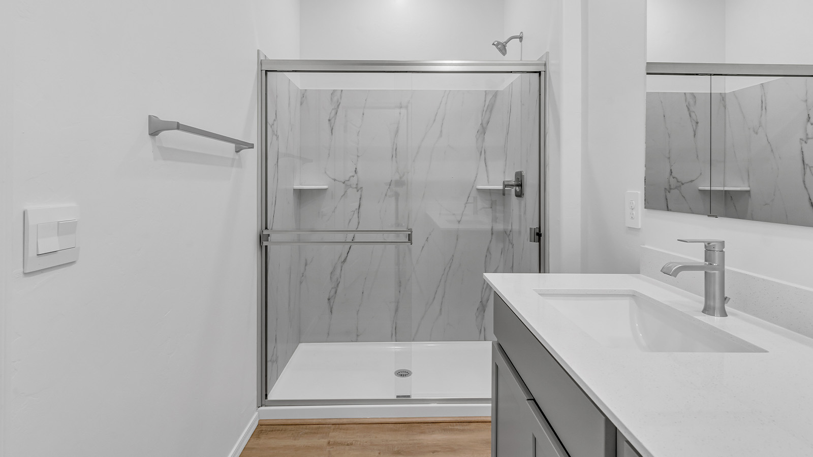 Introducing The Brooke at Coronet at Gladden Farms in Marana, Arizona – a unique 1,654 sq. ft. single-story new home designed for those who seek both comfort and style in a picturesque setting. Exclusively available at Coronet at Gladden Farms, this floorplan offers a one-of-a-kind living experience you won’t find anywhere else.  As you enter through the welcoming front porch, you’ll find yourself in a well-designed entryway that leads into the heart of the home. The great room, with its open and airy layout, is the perfect spot for gathering with family and friends. It flows seamlessly into the dining area and kitchen, creating an inviting space that’s ideal for everything from casual meals to entertaining guests.  The kitchen is the centerpiece of this home, featuring quartz countertops, modern appliances, and a large pantry that provides ample storage. The adjacent dining area offers a comfortable setting for meals, and the open-concept design ensures that the kitchen, dining, and living spaces are always connected.  The Brooke offers a well-thought-out floor plan with four bedrooms, making it perfect for families of all sizes. The master suite, located at the rear of the home, provides a private retreat with a spacious bedroom, a walk-in closet, and an en-suite bathroom complete with dual vanities and a walk-in shower. The additional three bedrooms are thoughtfully positioned near the second full bathroom, ensuring comfort and convenience for all.  A utility room and a two-car garage add practicality to the overall design, while the covered patio extends your living space outdoors. Here, you can enjoy Arizona’s beautiful weather and the stunning views that Coronet at Gladden Farms has to offer.  Designed with energy efficiency in mind, The Brooke at Coronet at Gladden Farms is a DOE Zero Energy Ready Home, providing a sustainable lifestyle with lower utility costs and a reduced environmental footprint.