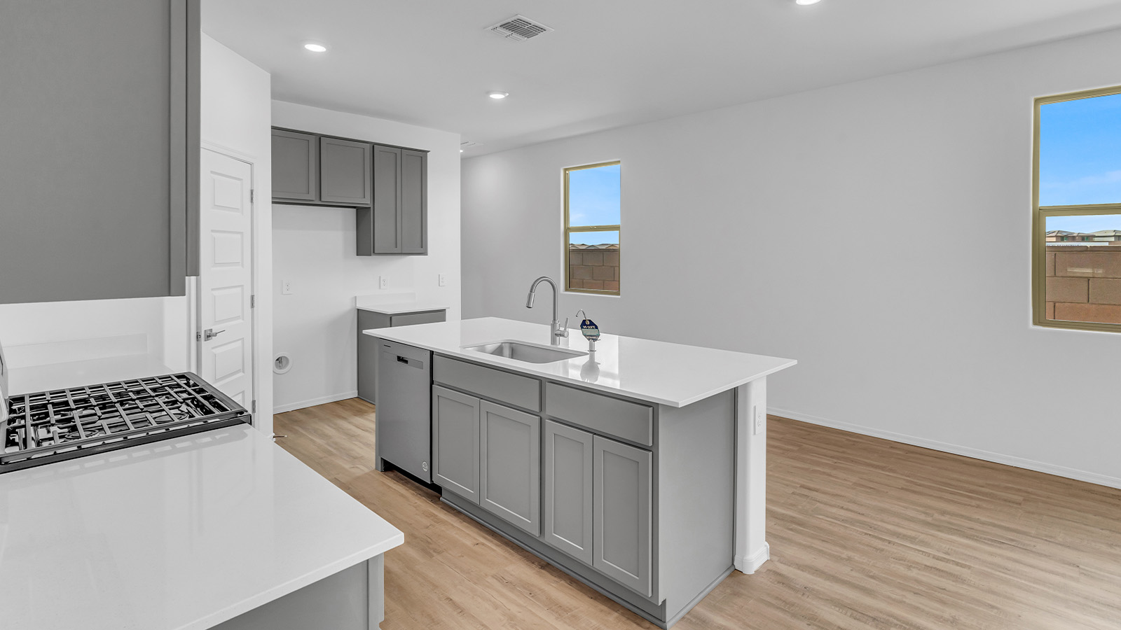 Introducing The Brooke at Coronet at Gladden Farms in Marana, Arizona – a unique 1,654 sq. ft. single-story new home designed for those who seek both comfort and style in a picturesque setting. Exclusively available at Coronet at Gladden Farms, this floorplan offers a one-of-a-kind living experience you won’t find anywhere else.  As you enter through the welcoming front porch, you’ll find yourself in a well-designed entryway that leads into the heart of the home. The great room, with its open and airy layout, is the perfect spot for gathering with family and friends. It flows seamlessly into the dining area and kitchen, creating an inviting space that’s ideal for everything from casual meals to entertaining guests.  The kitchen is the centerpiece of this home, featuring quartz countertops, modern appliances, and a large pantry that provides ample storage. The adjacent dining area offers a comfortable setting for meals, and the open-concept design ensures that the kitchen, dining, and living spaces are always connected.  The Brooke offers a well-thought-out floor plan with four bedrooms, making it perfect for families of all sizes. The master suite, located at the rear of the home, provides a private retreat with a spacious bedroom, a walk-in closet, and an en-suite bathroom complete with dual vanities and a walk-in shower. The additional three bedrooms are thoughtfully positioned near the second full bathroom, ensuring comfort and convenience for all.  A utility room and a two-car garage add practicality to the overall design, while the covered patio extends your living space outdoors. Here, you can enjoy Arizona’s beautiful weather and the stunning views that Coronet at Gladden Farms has to offer.  Designed with energy efficiency in mind, The Brooke at Coronet at Gladden Farms is a DOE Zero Energy Ready Home, providing a sustainable lifestyle with lower utility costs and a reduced environmental footprint.