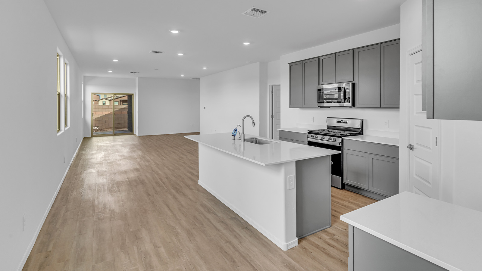 Introducing The Brooke at Coronet at Gladden Farms in Marana, Arizona – a unique 1,654 sq. ft. single-story new home designed for those who seek both comfort and style in a picturesque setting. Exclusively available at Coronet at Gladden Farms, this floorplan offers a one-of-a-kind living experience you won’t find anywhere else.  As you enter through the welcoming front porch, you’ll find yourself in a well-designed entryway that leads into the heart of the home. The great room, with its open and airy layout, is the perfect spot for gathering with family and friends. It flows seamlessly into the dining area and kitchen, creating an inviting space that’s ideal for everything from casual meals to entertaining guests.  The kitchen is the centerpiece of this home, featuring quartz countertops, modern appliances, and a large pantry that provides ample storage. The adjacent dining area offers a comfortable setting for meals, and the open-concept design ensures that the kitchen, dining, and living spaces are always connected.  The Brooke offers a well-thought-out floor plan with four bedrooms, making it perfect for families of all sizes. The master suite, located at the rear of the home, provides a private retreat with a spacious bedroom, a walk-in closet, and an en-suite bathroom complete with dual vanities and a walk-in shower. The additional three bedrooms are thoughtfully positioned near the second full bathroom, ensuring comfort and convenience for all.  A utility room and a two-car garage add practicality to the overall design, while the covered patio extends your living space outdoors. Here, you can enjoy Arizona’s beautiful weather and the stunning views that Coronet at Gladden Farms has to offer.  Designed with energy efficiency in mind, The Brooke at Coronet at Gladden Farms is a DOE Zero Energy Ready Home, providing a sustainable lifestyle with lower utility costs and a reduced environmental footprint.