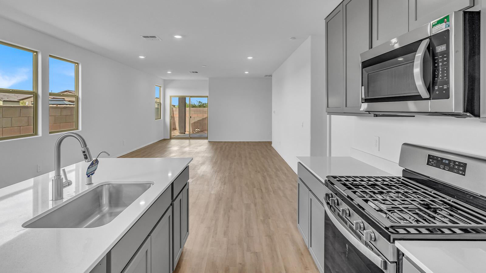 Introducing The Brooke at Coronet at Gladden Farms in Marana, Arizona – a unique 1,654 sq. ft. single-story new home designed for those who seek both comfort and style in a picturesque setting. Exclusively available at Coronet at Gladden Farms, this floorplan offers a one-of-a-kind living experience you won’t find anywhere else.  As you enter through the welcoming front porch, you’ll find yourself in a well-designed entryway that leads into the heart of the home. The great room, with its open and airy layout, is the perfect spot for gathering with family and friends. It flows seamlessly into the dining area and kitchen, creating an inviting space that’s ideal for everything from casual meals to entertaining guests.  The kitchen is the centerpiece of this home, featuring quartz countertops, modern appliances, and a large pantry that provides ample storage. The adjacent dining area offers a comfortable setting for meals, and the open-concept design ensures that the kitchen, dining, and living spaces are always connected.  The Brooke offers a well-thought-out floor plan with four bedrooms, making it perfect for families of all sizes. The master suite, located at the rear of the home, provides a private retreat with a spacious bedroom, a walk-in closet, and an en-suite bathroom complete with dual vanities and a walk-in shower. The additional three bedrooms are thoughtfully positioned near the second full bathroom, ensuring comfort and convenience for all.  A utility room and a two-car garage add practicality to the overall design, while the covered patio extends your living space outdoors. Here, you can enjoy Arizona’s beautiful weather and the stunning views that Coronet at Gladden Farms has to offer.  Designed with energy efficiency in mind, The Brooke at Coronet at Gladden Farms is a DOE Zero Energy Ready Home, providing a sustainable lifestyle with lower utility costs and a reduced environmental footprint.