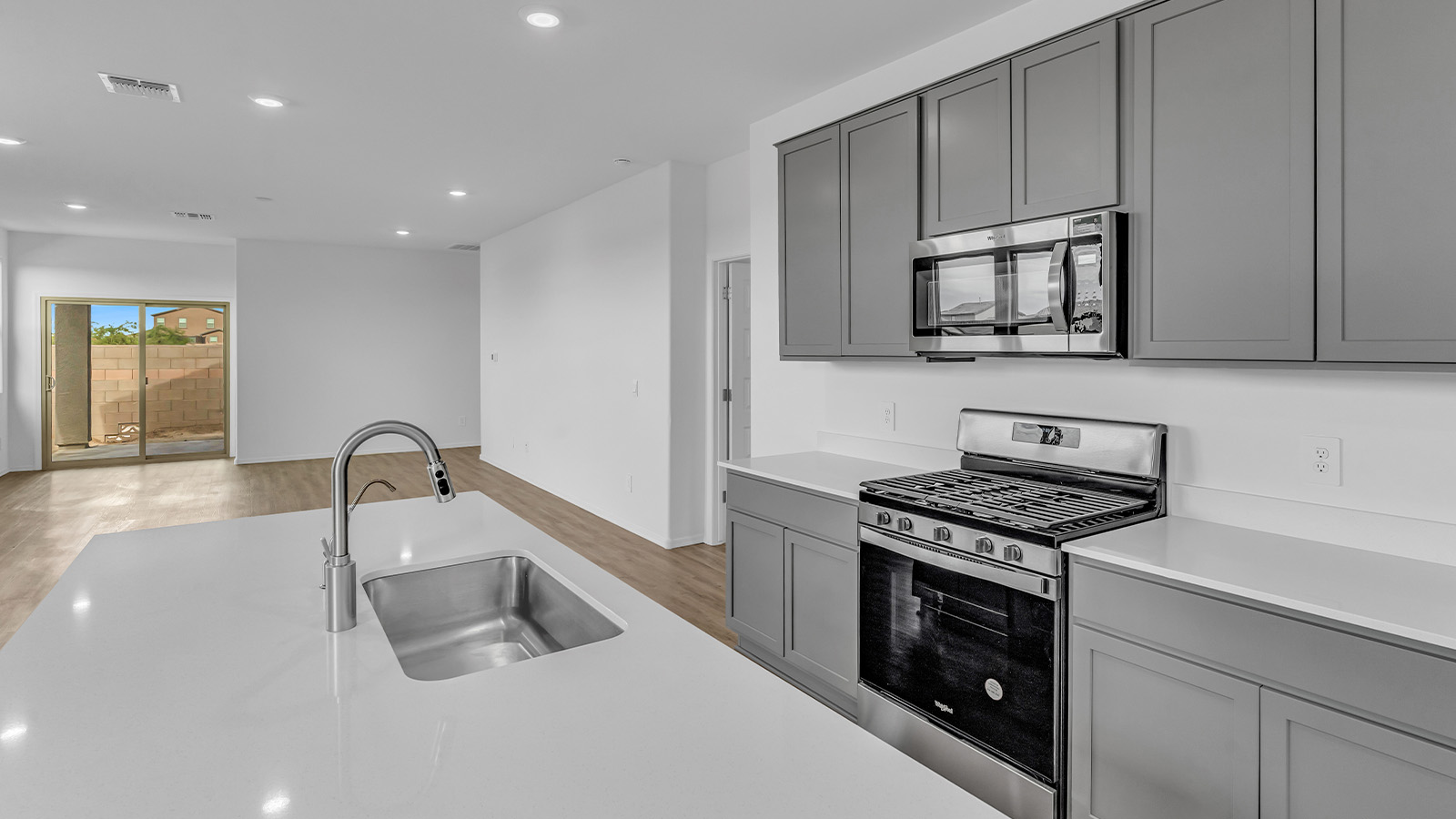 Introducing The Brooke at Coronet at Gladden Farms in Marana, Arizona – a unique 1,654 sq. ft. single-story new home designed for those who seek both comfort and style in a picturesque setting. Exclusively available at Coronet at Gladden Farms, this floorplan offers a one-of-a-kind living experience you won’t find anywhere else.  As you enter through the welcoming front porch, you’ll find yourself in a well-designed entryway that leads into the heart of the home. The great room, with its open and airy layout, is the perfect spot for gathering with family and friends. It flows seamlessly into the dining area and kitchen, creating an inviting space that’s ideal for everything from casual meals to entertaining guests.  The kitchen is the centerpiece of this home, featuring quartz countertops, modern appliances, and a large pantry that provides ample storage. The adjacent dining area offers a comfortable setting for meals, and the open-concept design ensures that the kitchen, dining, and living spaces are always connected.  The Brooke offers a well-thought-out floor plan with four bedrooms, making it perfect for families of all sizes. The master suite, located at the rear of the home, provides a private retreat with a spacious bedroom, a walk-in closet, and an en-suite bathroom complete with dual vanities and a walk-in shower. The additional three bedrooms are thoughtfully positioned near the second full bathroom, ensuring comfort and convenience for all.  A utility room and a two-car garage add practicality to the overall design, while the covered patio extends your living space outdoors. Here, you can enjoy Arizona’s beautiful weather and the stunning views that Coronet at Gladden Farms has to offer.  Designed with energy efficiency in mind, The Brooke at Coronet at Gladden Farms is a DOE Zero Energy Ready Home, providing a sustainable lifestyle with lower utility costs and a reduced environmental footprint.