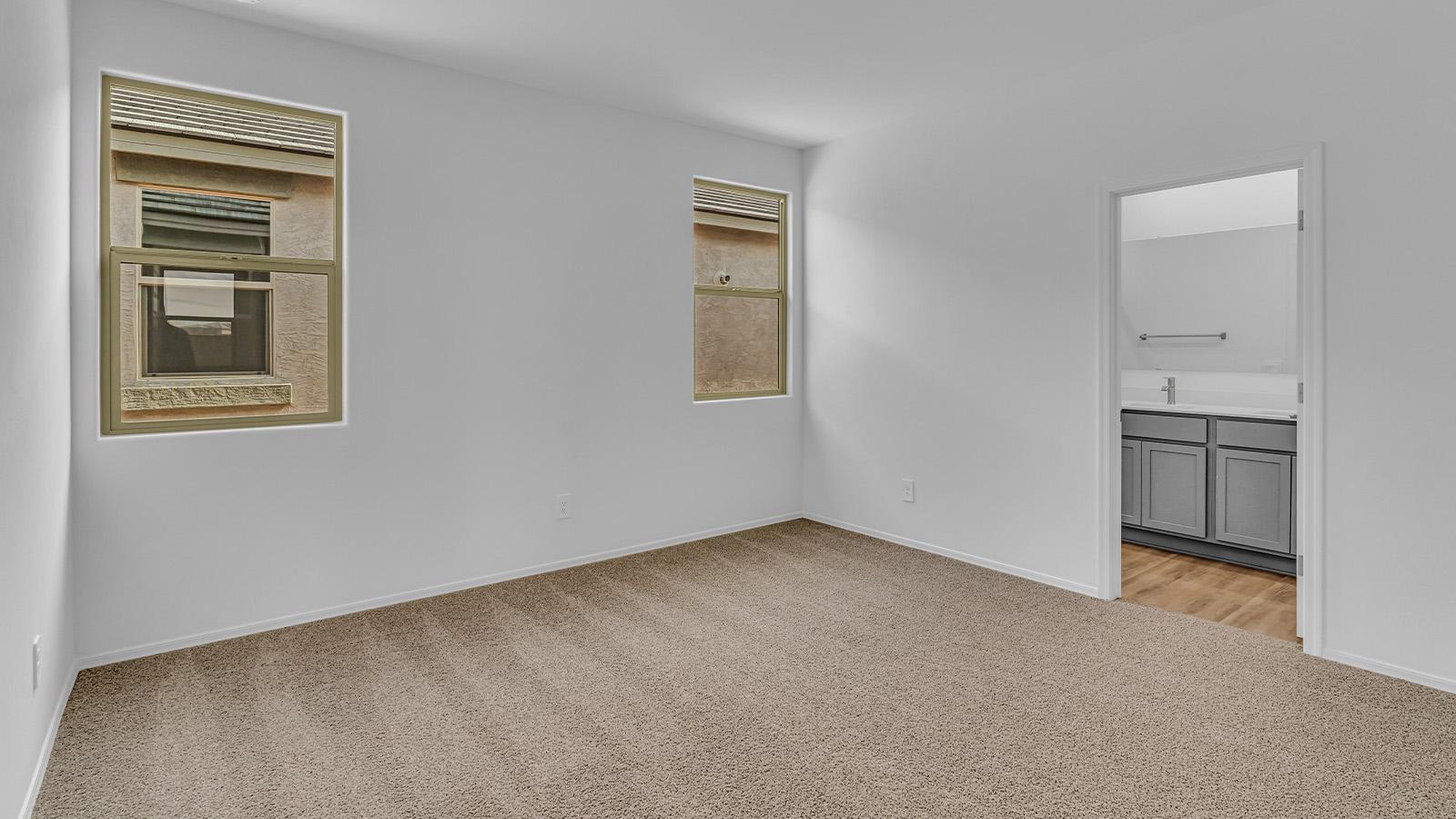 Introducing The Brooke at Coronet at Gladden Farms in Marana, Arizona – a unique 1,654 sq. ft. single-story new home designed for those who seek both comfort and style in a picturesque setting. Exclusively available at Coronet at Gladden Farms, this floorplan offers a one-of-a-kind living experience you won’t find anywhere else.  As you enter through the welcoming front porch, you’ll find yourself in a well-designed entryway that leads into the heart of the home. The great room, with its open and airy layout, is the perfect spot for gathering with family and friends. It flows seamlessly into the dining area and kitchen, creating an inviting space that’s ideal for everything from casual meals to entertaining guests.  The kitchen is the centerpiece of this home, featuring quartz countertops, modern appliances, and a large pantry that provides ample storage. The adjacent dining area offers a comfortable setting for meals, and the open-concept design ensures that the kitchen, dining, and living spaces are always connected.  The Brooke offers a well-thought-out floor plan with four bedrooms, making it perfect for families of all sizes. The master suite, located at the rear of the home, provides a private retreat with a spacious bedroom, a walk-in closet, and an en-suite bathroom complete with dual vanities and a walk-in shower. The additional three bedrooms are thoughtfully positioned near the second full bathroom, ensuring comfort and convenience for all.  A utility room and a two-car garage add practicality to the overall design, while the covered patio extends your living space outdoors. Here, you can enjoy Arizona’s beautiful weather and the stunning views that Coronet at Gladden Farms has to offer.  Designed with energy efficiency in mind, The Brooke at Coronet at Gladden Farms is a DOE Zero Energy Ready Home, providing a sustainable lifestyle with lower utility costs and a reduced environmental footprint.