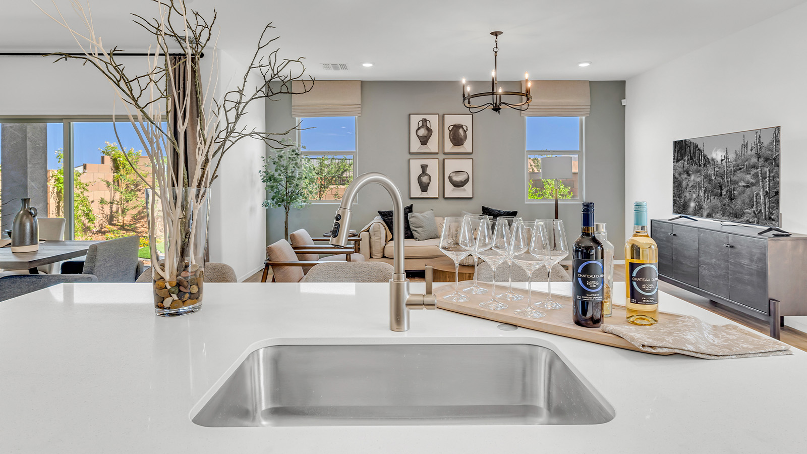 Welcome to The Kate at Coronet at Gladden Farms in Marana, Arizona – a spacious 2,227 sq. ft. two-story home designed to offer both luxury and practicality in a vibrant community setting.  As you step through the welcoming front porch, you’re greeted by an expansive entryway that leads into the heart of the home. The main floor features a generous great room that seamlessly flows into the dining area and kitchen, creating a perfect space for family gatherings and entertaining guests. The kitchen is a chef’s delight with modern appliances and ample storage space.  The main floor also includes a convenient powder room for guests and direct access to the two-car garage, enhancing the home’s functionality.  Upstairs, the primary suite offers a peaceful retreat, complete with a spacious bedroom, a large walk-in closet, and an en-suite bathroom and a walk-in shower. The upper level also includes three additional bedrooms, a full bathroom, and a centrally located utility room for added convenience. A versatile loft area provides additional living space, perfect for a playroom, home office, or secondary lounge.  The Kate in Coronet at Gladden Farms is designed with energy efficiency at its core featuring advanced energy-saving technologies such as a tankless water heater, energy-efficient LED lighting, and high-performance spray foam insulation, helping to lower utility costs.  Living at Coronet at Gladden Farms means more than just having a beautiful home. Residents enjoy access to 830 acres of green space, 28 parks, 19 playgrounds, and exclusive amenities like a sparkling community pool, fitness center, and clubhouse. The gated community also offers walking trails, a dog park, and close proximity to everyday conveniences, making it an ideal environment for families and active lifestyles.