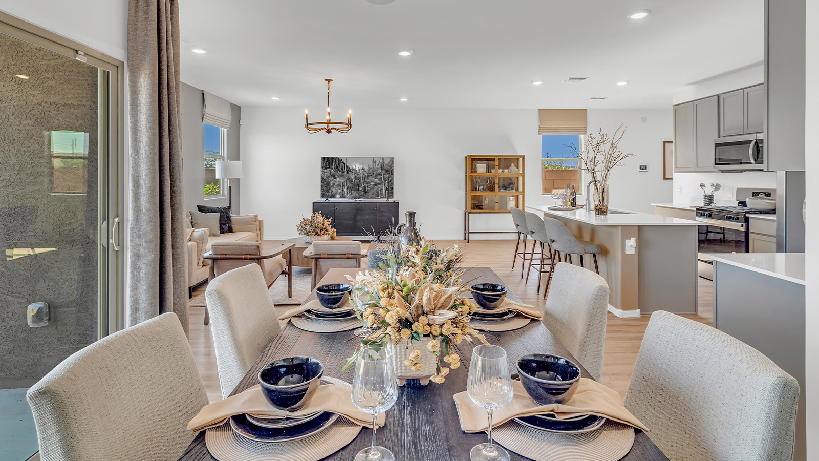 Welcome to The Kate at Coronet at Gladden Farms in Marana, Arizona – a spacious 2,227 sq. ft. two-story home designed to offer both luxury and practicality in a vibrant community setting.  As you step through the welcoming front porch, you’re greeted by an expansive entryway that leads into the heart of the home. The main floor features a generous great room that seamlessly flows into the dining area and kitchen, creating a perfect space for family gatherings and entertaining guests. The kitchen is a chef’s delight with modern appliances and ample storage space.  The main floor also includes a convenient powder room for guests and direct access to the two-car garage, enhancing the home’s functionality.  Upstairs, the primary suite offers a peaceful retreat, complete with a spacious bedroom, a large walk-in closet, and an en-suite bathroom and a walk-in shower. The upper level also includes three additional bedrooms, a full bathroom, and a centrally located utility room for added convenience. A versatile loft area provides additional living space, perfect for a playroom, home office, or secondary lounge.  The Kate in Coronet at Gladden Farms is designed with energy efficiency at its core featuring advanced energy-saving technologies such as a tankless water heater, energy-efficient LED lighting, and high-performance spray foam insulation, helping to lower utility costs.  Living at Coronet at Gladden Farms means more than just having a beautiful home. Residents enjoy access to 830 acres of green space, 28 parks, 19 playgrounds, and exclusive amenities like a sparkling community pool, fitness center, and clubhouse. The gated community also offers walking trails, a dog park, and close proximity to everyday conveniences, making it an ideal environment for families and active lifestyles.