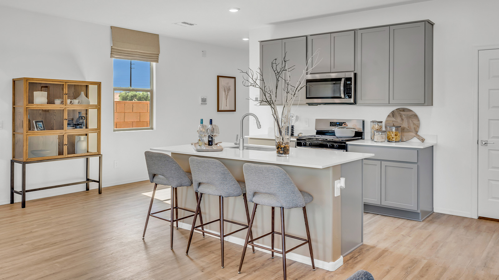 Welcome to The Kate at Coronet at Gladden Farms in Marana, Arizona – a spacious 2,227 sq. ft. two-story home designed to offer both luxury and practicality in a vibrant community setting.  As you step through the welcoming front porch, you’re greeted by an expansive entryway that leads into the heart of the home. The main floor features a generous great room that seamlessly flows into the dining area and kitchen, creating a perfect space for family gatherings and entertaining guests. The kitchen is a chef’s delight with modern appliances and ample storage space.  The main floor also includes a convenient powder room for guests and direct access to the two-car garage, enhancing the home’s functionality.  Upstairs, the primary suite offers a peaceful retreat, complete with a spacious bedroom, a large walk-in closet, and an en-suite bathroom and a walk-in shower. The upper level also includes three additional bedrooms, a full bathroom, and a centrally located utility room for added convenience. A versatile loft area provides additional living space, perfect for a playroom, home office, or secondary lounge.  The Kate in Coronet at Gladden Farms is designed with energy efficiency at its core featuring advanced energy-saving technologies such as a tankless water heater, energy-efficient LED lighting, and high-performance spray foam insulation, helping to lower utility costs.  Living at Coronet at Gladden Farms means more than just having a beautiful home. Residents enjoy access to 830 acres of green space, 28 parks, 19 playgrounds, and exclusive amenities like a sparkling community pool, fitness center, and clubhouse. The gated community also offers walking trails, a dog park, and close proximity to everyday conveniences, making it an ideal environment for families and active lifestyles.