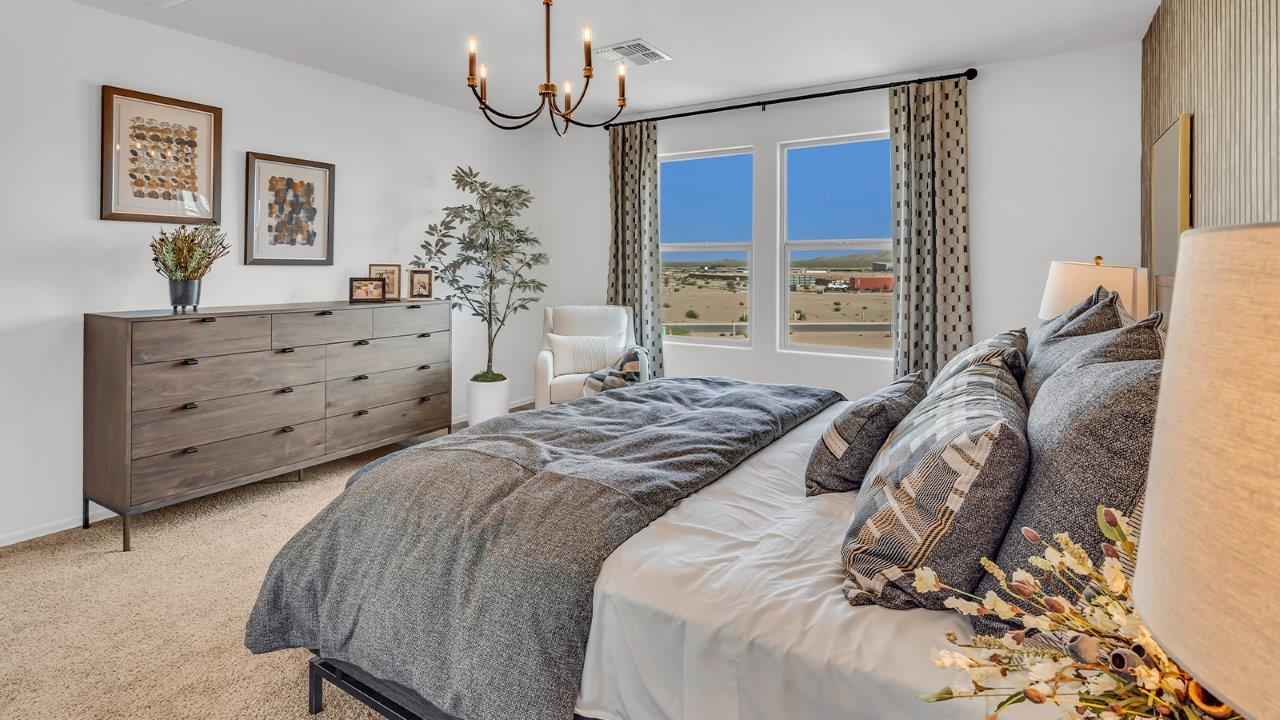 Welcome to The Kate at Coronet at Gladden Farms in Marana, Arizona – a spacious 2,227 sq. ft. two-story home designed to offer both luxury and practicality in a vibrant community setting.  As you step through the welcoming front porch, you’re greeted by an expansive entryway that leads into the heart of the home. The main floor features a generous great room that seamlessly flows into the dining area and kitchen, creating a perfect space for family gatherings and entertaining guests. The kitchen is a chef’s delight, boasting quartz countertops, a large island with a breakfast bar, modern appliances, and a walk-in pantry that provides ample storage.  The main floor also includes a convenient powder room for guests and direct access to the two-car garage, enhancing the home’s functionality. Just off the kitchen and dining room, a covered patio invites you to enjoy the beautiful Arizona weather, offering a serene spot for outdoor dining or relaxation.  Upstairs, the master suite offers a peaceful retreat, complete with a spacious bedroom, a large walk-in closet, and an en-suite bathroom featuring dual vanities and a walk-in shower. The upper level also includes three additional bedrooms, a full bathroom, and a centrally located utility room for added convenience. A versatile loft area provides additional living space, perfect for a playroom, home office, or secondary lounge.  The Kate in Coronet at Gladden Farms is designed with energy efficiency at its core. This DOE Zero Energy Ready Home features advanced energy-saving technologies such as tankless water heaters, energy-efficient LED lighting, and high-performance spray foam insulation, ensuring lower utility costs and a reduced environmental footprint.  Living at Coronet at Gladden Farms means more than just having a beautiful home. Residents enjoy access to 830 acres of green space, 28 parks, 19 playgrounds, and exclusive amenities like a sparkling community pool, fitness center, and clubhouse. The gated community also offers walking trails, a dog park, and close proximity to everyday conveniences, making it an ideal environment for families and active lifestyles.  *Images shown are for reference only. They depict the sales model home and may not represent the actual home.