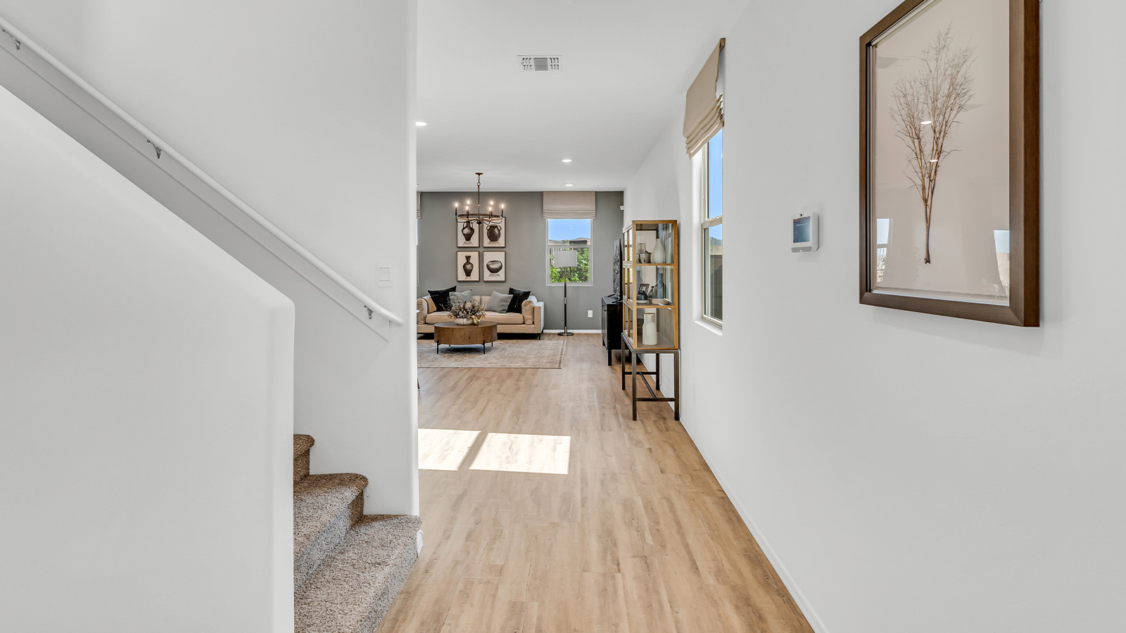 Welcome to The Kate at Coronet at Gladden Farms in Marana, Arizona – a spacious 2,227 sq. ft. two-story home designed to offer both luxury and practicality in a vibrant community setting.  As you step through the welcoming front porch, you’re greeted by an expansive entryway that leads into the heart of the home. The main floor features a generous great room that seamlessly flows into the dining area and kitchen, creating a perfect space for family gatherings and entertaining guests. The kitchen is a chef’s delight, boasting quartz countertops, a large island with a breakfast bar, modern appliances, and a walk-in pantry that provides ample storage.  The main floor also includes a convenient powder room for guests and direct access to the two-car garage, enhancing the home’s functionality. Just off the kitchen and dining room, a covered patio invites you to enjoy the beautiful Arizona weather, offering a serene spot for outdoor dining or relaxation.  Upstairs, the master suite offers a peaceful retreat, complete with a spacious bedroom, a large walk-in closet, and an en-suite bathroom featuring dual vanities and a walk-in shower. The upper level also includes three additional bedrooms, a full bathroom, and a centrally located utility room for added convenience. A versatile loft area provides additional living space, perfect for a playroom, home office, or secondary lounge.  The Kate in Coronet at Gladden Farms is designed with energy efficiency at its core. This DOE Zero Energy Ready Home features advanced energy-saving technologies such as tankless water heaters, energy-efficient LED lighting, and high-performance spray foam insulation, ensuring lower utility costs and a reduced environmental footprint.  Living at Coronet at Gladden Farms means more than just having a beautiful home. Residents enjoy access to 830 acres of green space, 28 parks, 19 playgrounds, and exclusive amenities like a sparkling community pool, fitness center, and clubhouse. The gated community also offers walking trails, a dog park, and close proximity to everyday conveniences, making it an ideal environment for families and active lifestyles.