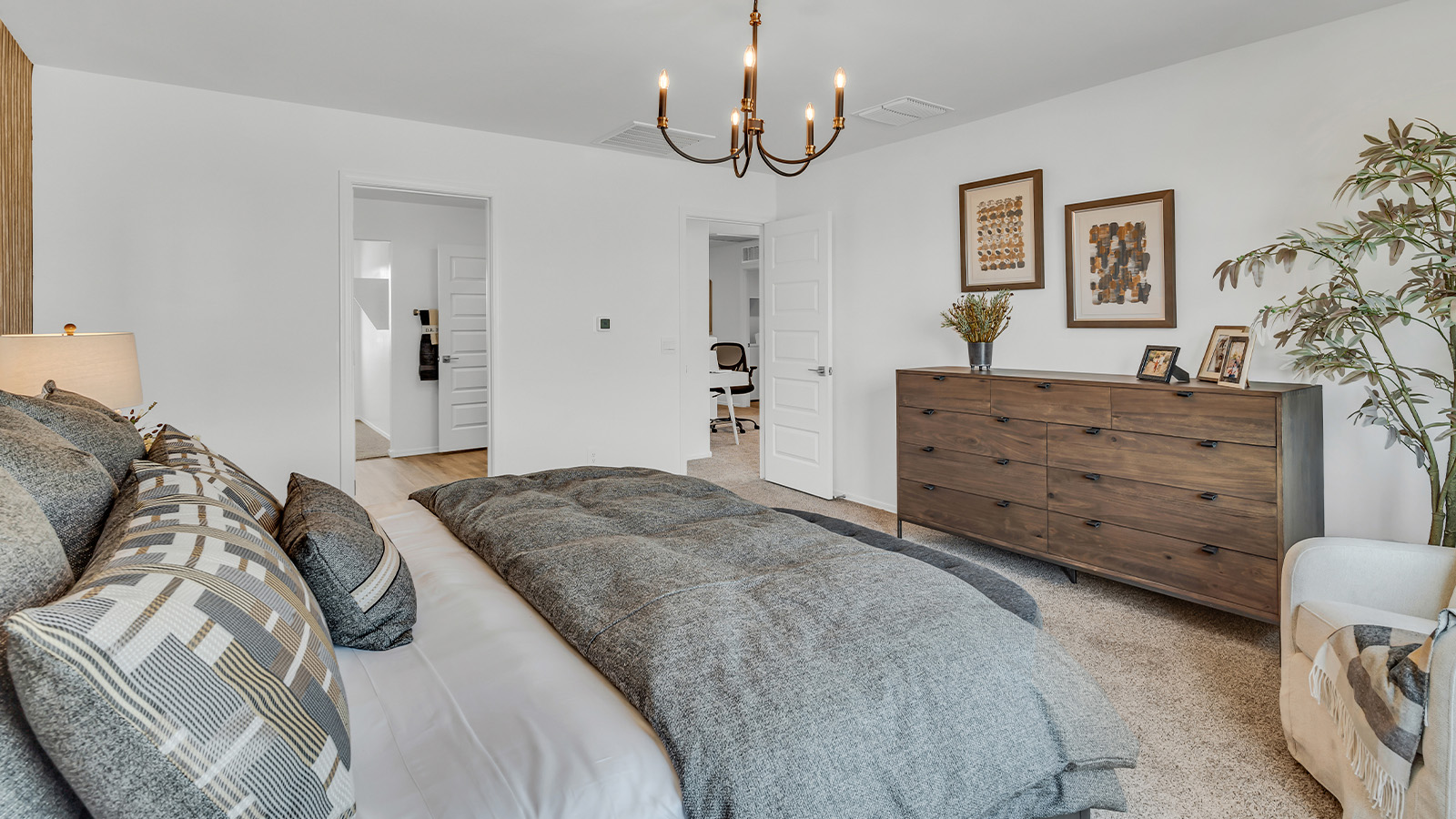 Welcome to The Kate at Coronet at Gladden Farms in Marana, Arizona – a spacious 2,227 sq. ft. two-story home designed to offer both luxury and practicality in a vibrant community setting.  As you step through the welcoming front porch, you’re greeted by an expansive entryway that leads into the heart of the home. The main floor features a generous great room that seamlessly flows into the dining area and kitchen, creating a perfect space for family gatherings and entertaining guests. The kitchen is a chef’s delight, boasting quartz countertops, a large island with a breakfast bar, modern appliances, and a walk-in pantry that provides ample storage.  The main floor also includes a convenient powder room for guests and direct access to the two-car garage, enhancing the home’s functionality. Just off the kitchen and dining room, a covered patio invites you to enjoy the beautiful Arizona weather, offering a serene spot for outdoor dining or relaxation.  Upstairs, the master suite offers a peaceful retreat, complete with a spacious bedroom, a large walk-in closet, and an en-suite bathroom featuring dual vanities and a walk-in shower. The upper level also includes three additional bedrooms, a full bathroom, and a centrally located utility room for added convenience. A versatile loft area provides additional living space, perfect for a playroom, home office, or secondary lounge.  The Kate in Coronet at Gladden Farms is designed with energy efficiency at its core. This DOE Zero Energy Ready Home features advanced energy-saving technologies such as tankless water heaters, energy-efficient LED lighting, and high-performance spray foam insulation, ensuring lower utility costs and a reduced environmental footprint.  Living at Coronet at Gladden Farms means more than just having a beautiful home. Residents enjoy access to 830 acres of green space, 28 parks, 19 playgrounds, and exclusive amenities like a sparkling community pool, fitness center, and clubhouse. The gated community also offers walking trails, a dog park, and close proximity to everyday conveniences, making it an ideal environment for families and active lifestyles.