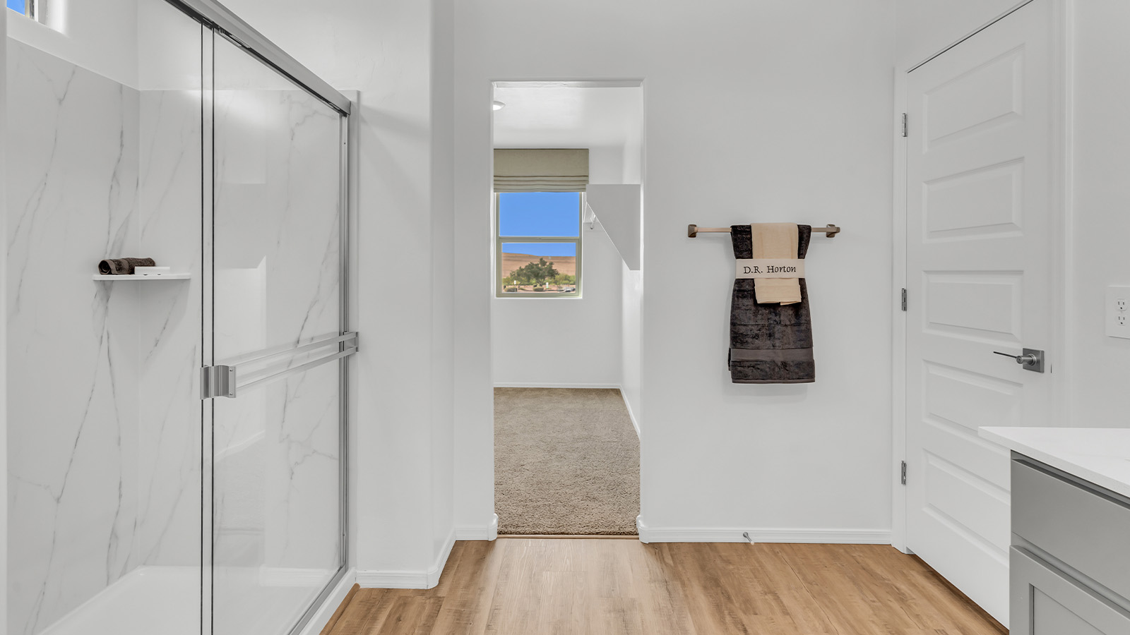 Welcome to The Kate at Coronet at Gladden Farms in Marana, Arizona – a spacious 2,227 sq. ft. two-story home designed to offer both luxury and practicality in a vibrant community setting.  As you step through the welcoming front porch, you’re greeted by an expansive entryway that leads into the heart of the home. The main floor features a generous great room that seamlessly flows into the dining area and kitchen, creating a perfect space for family gatherings and entertaining guests. The kitchen is a chef’s delight, boasting quartz countertops, a large island with a breakfast bar, modern appliances, and a walk-in pantry that provides ample storage.  The main floor also includes a convenient powder room for guests and direct access to the two-car garage, enhancing the home’s functionality. Just off the kitchen and dining room, a covered patio invites you to enjoy the beautiful Arizona weather, offering a serene spot for outdoor dining or relaxation.  Upstairs, the master suite offers a peaceful retreat, complete with a spacious bedroom, a large walk-in closet, and an en-suite bathroom featuring dual vanities and a walk-in shower. The upper level also includes three additional bedrooms, a full bathroom, and a centrally located utility room for added convenience. A versatile loft area provides additional living space, perfect for a playroom, home office, or secondary lounge.  The Kate in Coronet at Gladden Farms is designed with energy efficiency at its core. This DOE Zero Energy Ready Home features advanced energy-saving technologies such as tankless water heaters, energy-efficient LED lighting, and high-performance spray foam insulation, ensuring lower utility costs and a reduced environmental footprint.  Living at Coronet at Gladden Farms means more than just having a beautiful home. Residents enjoy access to 830 acres of green space, 28 parks, 19 playgrounds, and exclusive amenities like a sparkling community pool, fitness center, and clubhouse. The gated community also offers walking trails, a dog park, and close proximity to everyday conveniences, making it an ideal environment for families and active lifestyles.