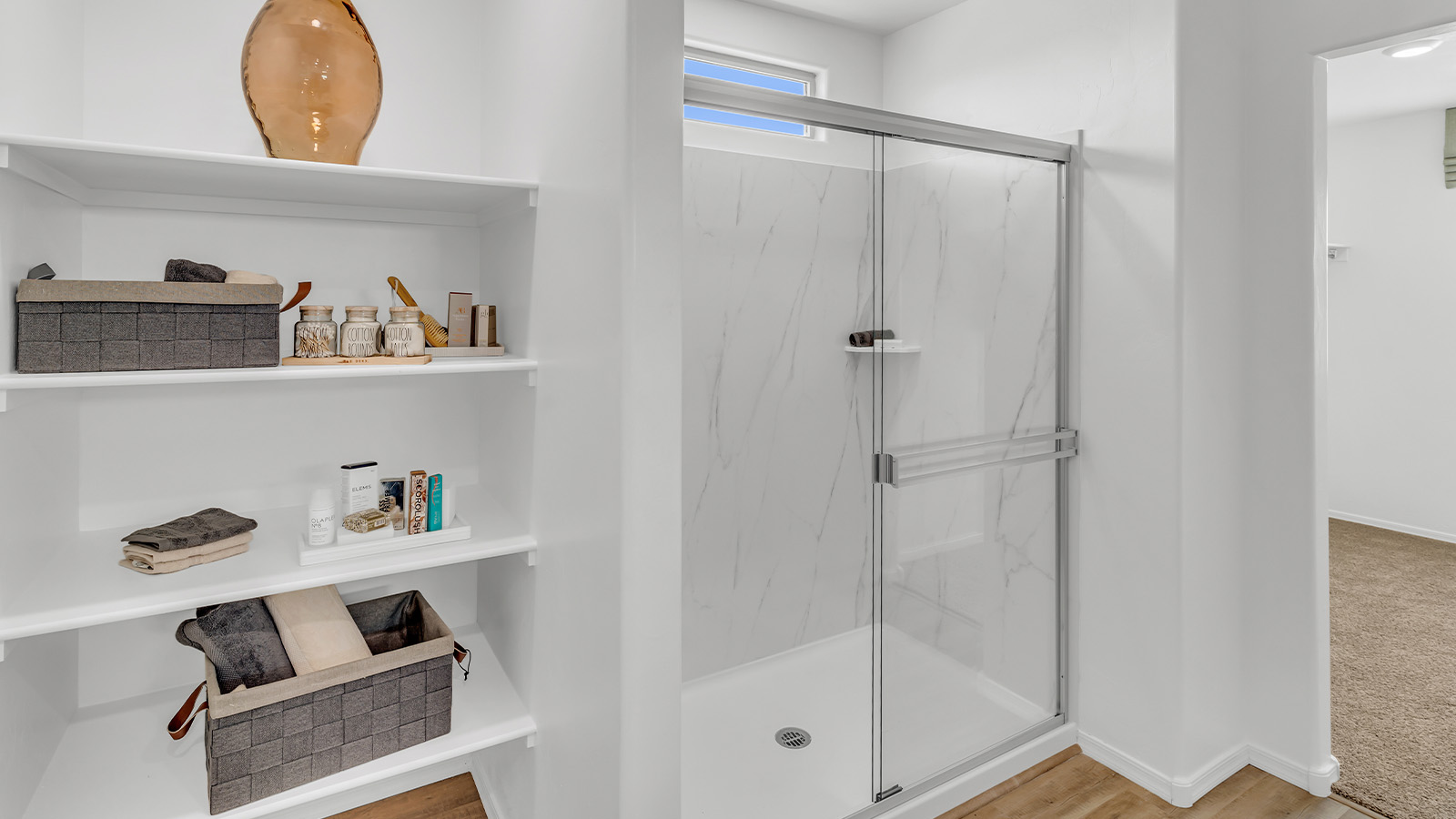 Welcome to The Kate at Coronet at Gladden Farms in Marana, Arizona – a spacious 2,227 sq. ft. two-story home designed to offer both luxury and practicality in a vibrant community setting.  As you step through the welcoming front porch, you’re greeted by an expansive entryway that leads into the heart of the home. The main floor features a generous great room that seamlessly flows into the dining area and kitchen, creating a perfect space for family gatherings and entertaining guests. The kitchen is a chef’s delight, boasting quartz countertops, a large island with a breakfast bar, modern appliances, and a walk-in pantry that provides ample storage.  The main floor also includes a convenient powder room for guests and direct access to the two-car garage, enhancing the home’s functionality. Just off the kitchen and dining room, a covered patio invites you to enjoy the beautiful Arizona weather, offering a serene spot for outdoor dining or relaxation.  Upstairs, the master suite offers a peaceful retreat, complete with a spacious bedroom, a large walk-in closet, and an en-suite bathroom featuring dual vanities and a walk-in shower. The upper level also includes three additional bedrooms, a full bathroom, and a centrally located utility room for added convenience. A versatile loft area provides additional living space, perfect for a playroom, home office, or secondary lounge.  The Kate in Coronet at Gladden Farms is designed with energy efficiency at its core. This DOE Zero Energy Ready Home features advanced energy-saving technologies such as tankless water heaters, energy-efficient LED lighting, and high-performance spray foam insulation, ensuring lower utility costs and a reduced environmental footprint.  Living at Coronet at Gladden Farms means more than just having a beautiful home. Residents enjoy access to 830 acres of green space, 28 parks, 19 playgrounds, and exclusive amenities like a sparkling community pool, fitness center, and clubhouse. The gated community also offers walking trails, a dog park, and close proximity to everyday conveniences, making it an ideal environment for families and active lifestyles.