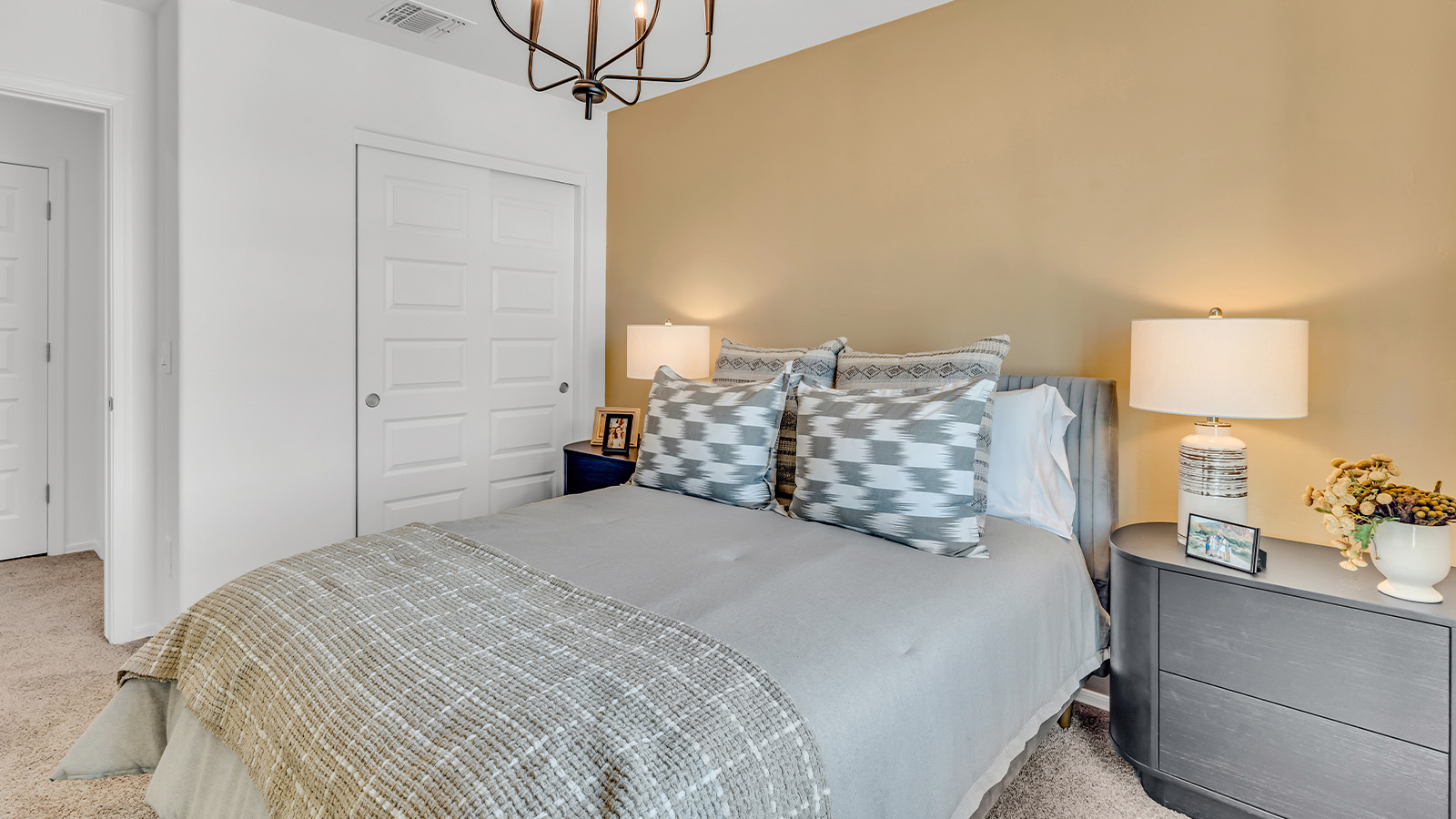 Welcome to The Kate at Coronet at Gladden Farms in Marana, Arizona – a spacious 2,227 sq. ft. two-story home designed to offer both luxury and practicality in a vibrant community setting.  As you step through the welcoming front porch, you’re greeted by an expansive entryway that leads into the heart of the home. The main floor features a generous great room that seamlessly flows into the dining area and kitchen, creating a perfect space for family gatherings and entertaining guests. The kitchen is a chef’s delight, boasting quartz countertops, a large island with a breakfast bar, modern appliances, and a walk-in pantry that provides ample storage.  The main floor also includes a convenient powder room for guests and direct access to the two-car garage, enhancing the home’s functionality. Just off the kitchen and dining room, a covered patio invites you to enjoy the beautiful Arizona weather, offering a serene spot for outdoor dining or relaxation.  Upstairs, the master suite offers a peaceful retreat, complete with a spacious bedroom, a large walk-in closet, and an en-suite bathroom featuring dual vanities and a walk-in shower. The upper level also includes three additional bedrooms, a full bathroom, and a centrally located utility room for added convenience. A versatile loft area provides additional living space, perfect for a playroom, home office, or secondary lounge.  The Kate in Coronet at Gladden Farms is designed with energy efficiency at its core. This DOE Zero Energy Ready Home features advanced energy-saving technologies such as tankless water heaters, energy-efficient LED lighting, and high-performance spray foam insulation, ensuring lower utility costs and a reduced environmental footprint.  Living at Coronet at Gladden Farms means more than just having a beautiful home. Residents enjoy access to 830 acres of green space, 28 parks, 19 playgrounds, and exclusive amenities like a sparkling community pool, fitness center, and clubhouse. The gated community also offers walking trails, a dog park, and close proximity to everyday conveniences, making it an ideal environment for families and active lifestyles.