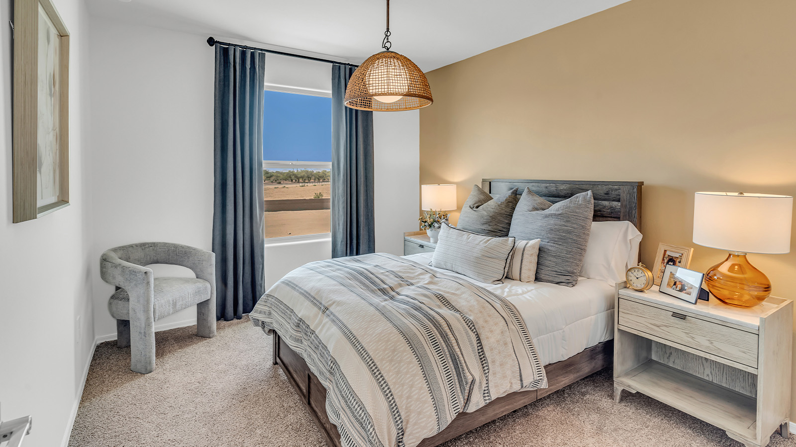 Welcome to The Kate at Coronet at Gladden Farms in Marana, Arizona – a spacious 2,227 sq. ft. two-story home designed to offer both luxury and practicality in a vibrant community setting.  As you step through the welcoming front porch, you’re greeted by an expansive entryway that leads into the heart of the home. The main floor features a generous great room that seamlessly flows into the dining area and kitchen, creating a perfect space for family gatherings and entertaining guests. The kitchen is a chef’s delight, boasting quartz countertops, a large island with a breakfast bar, modern appliances, and a walk-in pantry that provides ample storage.  The main floor also includes a convenient powder room for guests and direct access to the two-car garage, enhancing the home’s functionality. Just off the kitchen and dining room, a covered patio invites you to enjoy the beautiful Arizona weather, offering a serene spot for outdoor dining or relaxation.  Upstairs, the master suite offers a peaceful retreat, complete with a spacious bedroom, a large walk-in closet, and an en-suite bathroom featuring dual vanities and a walk-in shower. The upper level also includes three additional bedrooms, a full bathroom, and a centrally located utility room for added convenience. A versatile loft area provides additional living space, perfect for a playroom, home office, or secondary lounge.  The Kate in Coronet at Gladden Farms is designed with energy efficiency at its core. This DOE Zero Energy Ready Home features advanced energy-saving technologies such as tankless water heaters, energy-efficient LED lighting, and high-performance spray foam insulation, ensuring lower utility costs and a reduced environmental footprint.  Living at Coronet at Gladden Farms means more than just having a beautiful home. Residents enjoy access to 830 acres of green space, 28 parks, 19 playgrounds, and exclusive amenities like a sparkling community pool, fitness center, and clubhouse. The gated community also offers walking trails, a dog park, and close proximity to everyday conveniences, making it an ideal environment for families and active lifestyles.