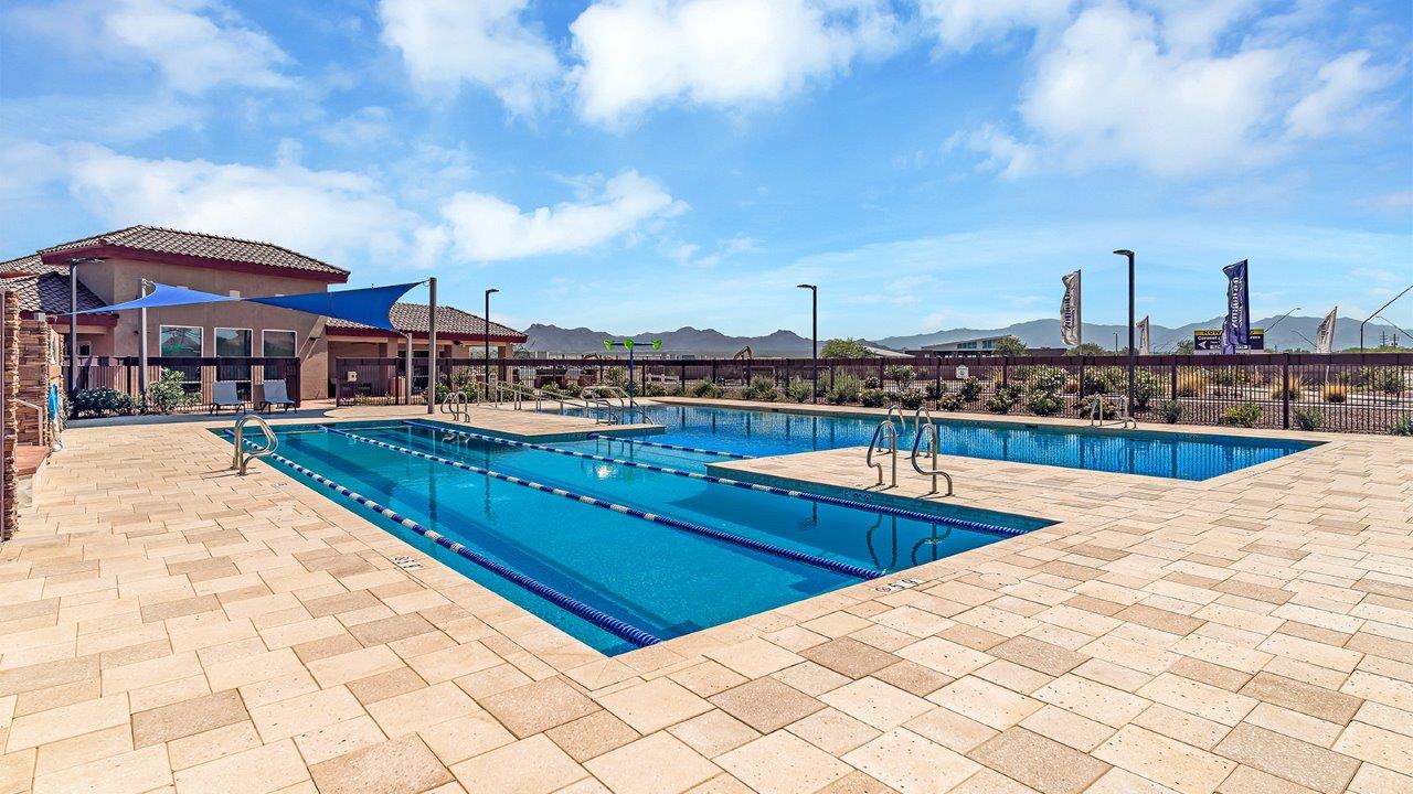 Welcome to The Kate at Coronet at Gladden Farms in Marana, Arizona – a spacious 2,227 sq. ft. two-story home designed to offer both luxury and practicality in a vibrant community setting.  As you step through the welcoming front porch, you’re greeted by an expansive entryway that leads into the heart of the home. The main floor features a generous great room that seamlessly flows into the dining area and kitchen, creating a perfect space for family gatherings and entertaining guests. The kitchen is a chef’s delight, boasting quartz countertops, a large island with a breakfast bar, modern appliances, and a walk-in pantry that provides ample storage.  The main floor also includes a convenient powder room for guests and direct access to the two-car garage, enhancing the home’s functionality. Just off the kitchen and dining room, a covered patio invites you to enjoy the beautiful Arizona weather, offering a serene spot for outdoor dining or relaxation.  Upstairs, the master suite offers a peaceful retreat, complete with a spacious bedroom, a large walk-in closet, and an en-suite bathroom featuring dual vanities and a walk-in shower. The upper level also includes three additional bedrooms, a full bathroom, and a centrally located utility room for added convenience. A versatile loft area provides additional living space, perfect for a playroom, home office, or secondary lounge.  The Kate in Coronet at Gladden Farms is designed with energy efficiency at its core. This DOE Zero Energy Ready Home features advanced energy-saving technologies such as tankless water heaters, energy-efficient LED lighting, and high-performance spray foam insulation, ensuring lower utility costs and a reduced environmental footprint.  Living at Coronet at Gladden Farms means more than just having a beautiful home. Residents enjoy access to 830 acres of green space, 28 parks, 19 playgrounds, and exclusive amenities like a sparkling community pool, fitness center, and clubhouse. The gated community also offers walking trails, a dog park, and close proximity to everyday conveniences, making it an ideal environment for families and active lifestyles.