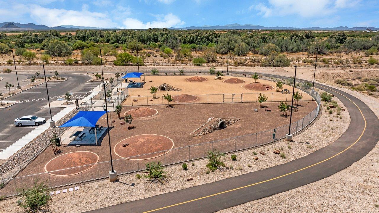 Welcome to The Kate at Coronet at Gladden Farms in Marana, Arizona – a spacious 2,227 sq. ft. two-story home designed to offer both luxury and practicality in a vibrant community setting.  As you step through the welcoming front porch, you’re greeted by an expansive entryway that leads into the heart of the home. The main floor features a generous great room that seamlessly flows into the dining area and kitchen, creating a perfect space for family gatherings and entertaining guests. The kitchen is a chef’s delight, boasting quartz countertops, a large island with a breakfast bar, modern appliances, and a walk-in pantry that provides ample storage.  The main floor also includes a convenient powder room for guests and direct access to the two-car garage, enhancing the home’s functionality. Just off the kitchen and dining room, a covered patio invites you to enjoy the beautiful Arizona weather, offering a serene spot for outdoor dining or relaxation.  Upstairs, the master suite offers a peaceful retreat, complete with a spacious bedroom, a large walk-in closet, and an en-suite bathroom featuring dual vanities and a walk-in shower. The upper level also includes three additional bedrooms, a full bathroom, and a centrally located utility room for added convenience. A versatile loft area provides additional living space, perfect for a playroom, home office, or secondary lounge.  The Kate in Coronet at Gladden Farms is designed with energy efficiency at its core. This DOE Zero Energy Ready Home features advanced energy-saving technologies such as tankless water heaters, energy-efficient LED lighting, and high-performance spray foam insulation, ensuring lower utility costs and a reduced environmental footprint.  Living at Coronet at Gladden Farms means more than just having a beautiful home. Residents enjoy access to 830 acres of green space, 28 parks, 19 playgrounds, and exclusive amenities like a sparkling community pool, fitness center, and clubhouse. The gated community also offers walking trails, a dog park, and close proximity to everyday conveniences, making it an ideal environment for families and active lifestyles.