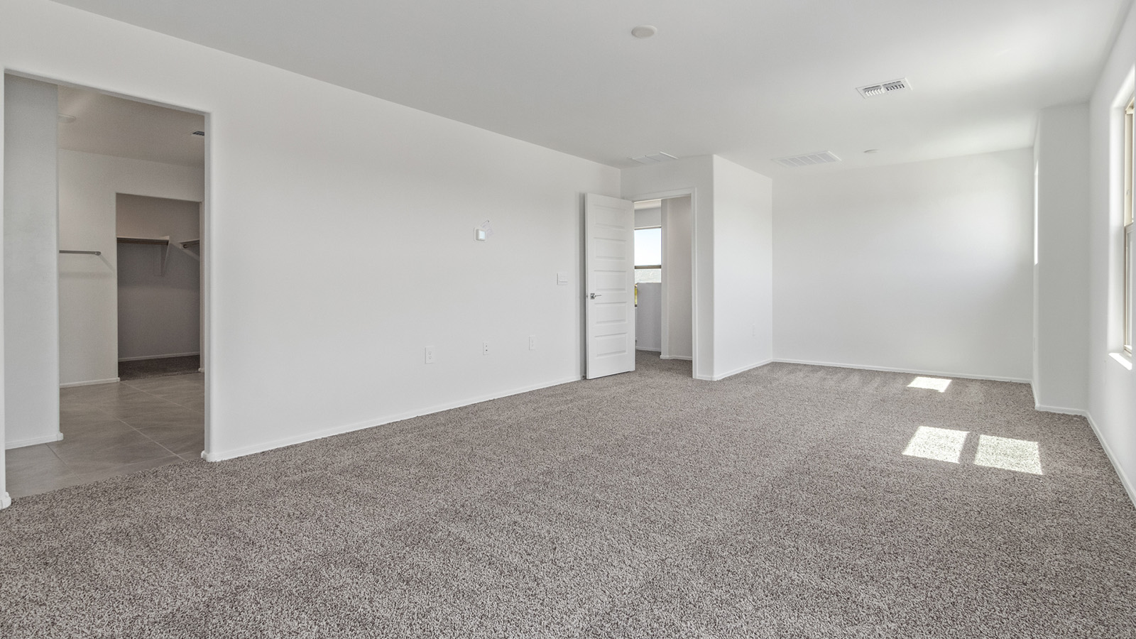 Welcome to The Madison within Coronet at Gladden Farms in Marana, Arizona – the largest new home in the community, offering an expansive 2,542 sq. ft. of living space designed to meet the needs of modern families.  As you step through the front porch, you’re welcomed into an entryway that opens up to the heart of the home. The main floor features a spacious great room that flows seamlessly into the dining area and kitchen, making it an ideal space for family gatherings and entertaining. The kitchen is a standout with its quartz countertops, large island, modern appliances, and a walk-in pantry.  On the main level, you'll also find a convenient bedroom and full bathroom, perfect for guests or as a private office space. The main floor’s design ensures both comfort and functionality, with direct access to the two-car garage and a covered patio that extends your living space outdoors.  Upstairs, the master suite offers a true retreat. The spacious bedroom leads to a large walk-in closet and an en-suite bathroom featuring dual vanities and a walk-in shower. The upper level also includes three additional bedrooms, a full bathroom, and a versatile loft area that can serve as a game room, home office, or second living area. A centrally located utility room adds convenience to everyday living.  Living at Coronet at Gladden Farms offers more than just a beautiful home. Residents enjoy exclusive amenities like a sparkling community pool, jacuzzi, fitness center, and clubhouse, along with access to 830 acres of green space, parks, playgrounds, and walking trails. This community is perfect for families who appreciate both comfort and outdoor adventure.  The Madison at Coronet at Gladden Farms is built with energy efficiency in mind, meeting DOE Zero Energy Ready Home standards. This means advanced features like tankless water heaters, energy-efficient LED lighting, and high-performance insulation are standard, ensuring lower utility costs and a reduced environmental footprint.