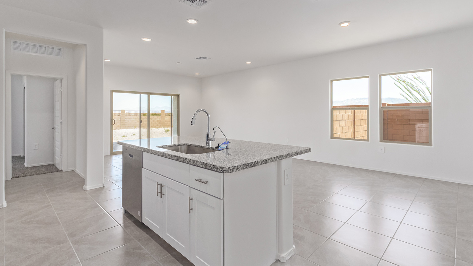 Welcome to The Madison within Coronet at Gladden Farms in Marana, Arizona – the largest new home in the community, offering an expansive 2,542 sq. ft. of living space designed to meet the needs of modern families.  As you step through the front porch, you’re welcomed into an entryway that opens up to the heart of the home. The main floor features a spacious great room that flows seamlessly into the dining area and kitchen, making it an ideal space for family gatherings and entertaining. The kitchen is a standout with its quartz countertops, large island, modern appliances, and a walk-in pantry.  On the main level, you'll also find a convenient bedroom and full bathroom, perfect for guests or as a private office space. The main floor’s design ensures both comfort and functionality, with direct access to the two-car garage and a covered patio that extends your living space outdoors.  Upstairs, the master suite offers a true retreat. The spacious bedroom leads to a large walk-in closet and an en-suite bathroom featuring dual vanities and a walk-in shower. The upper level also includes three additional bedrooms, a full bathroom, and a versatile loft area that can serve as a game room, home office, or second living area. A centrally located utility room adds convenience to everyday living.  Living at Coronet at Gladden Farms offers more than just a beautiful home. Residents enjoy exclusive amenities like a sparkling community pool, jacuzzi, fitness center, and clubhouse, along with access to 830 acres of green space, parks, playgrounds, and walking trails. This community is perfect for families who appreciate both comfort and outdoor adventure.  The Madison at Coronet at Gladden Farms is built with energy efficiency in mind, meeting DOE Zero Energy Ready Home standards. This means advanced features like tankless water heaters, energy-efficient LED lighting, and high-performance insulation are standard, ensuring lower utility costs and a reduced environmental footprint.