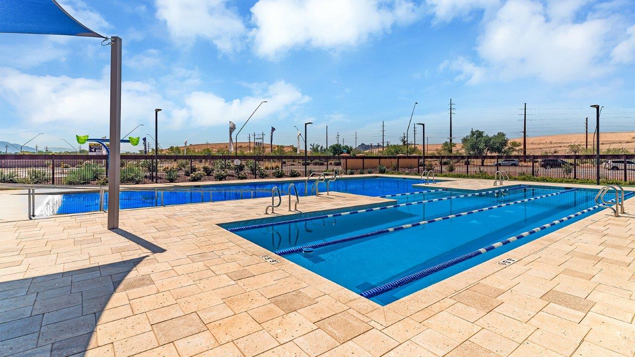 Welcome to The Madison within Coronet at Gladden Farms in Marana, Arizona – the largest new home in the community, offering an expansive 2,542 sq. ft. of living space designed to meet the needs of modern families.  As you step through the front porch, you’re welcomed into an entryway that opens up to the heart of the home. The main floor features a spacious great room that flows seamlessly into the dining area and kitchen, making it an ideal space for family gatherings and entertaining. The kitchen is a standout with its quartz countertops, large island, modern appliances, and a walk-in pantry.  On the main level, you'll also find a convenient bedroom and full bathroom, perfect for guests or as a private office space. The main floor’s design ensures both comfort and functionality, with direct access to the two-car garage and a covered patio that extends your living space outdoors.  Upstairs, the master suite offers a true retreat. The spacious bedroom leads to a large walk-in closet and an en-suite bathroom featuring dual vanities and a walk-in shower. The upper level also includes three additional bedrooms, a full bathroom, and a versatile loft area that can serve as a game room, home office, or second living area. A centrally located utility room adds convenience to everyday living.  Living at Coronet at Gladden Farms offers more than just a beautiful home. Residents enjoy exclusive amenities like a sparkling community pool, jacuzzi, fitness center, and clubhouse, along with access to 830 acres of green space, parks, playgrounds, and walking trails. This community is perfect for families who appreciate both comfort and outdoor adventure.  The Madison at Coronet at Gladden Farms is built with energy efficiency in mind, meeting DOE Zero Energy Ready Home standards. This means advanced features like tankless water heaters, energy-efficient LED lighting, and high-performance insulation are standard, ensuring lower utility costs and a reduced environmental footprint.