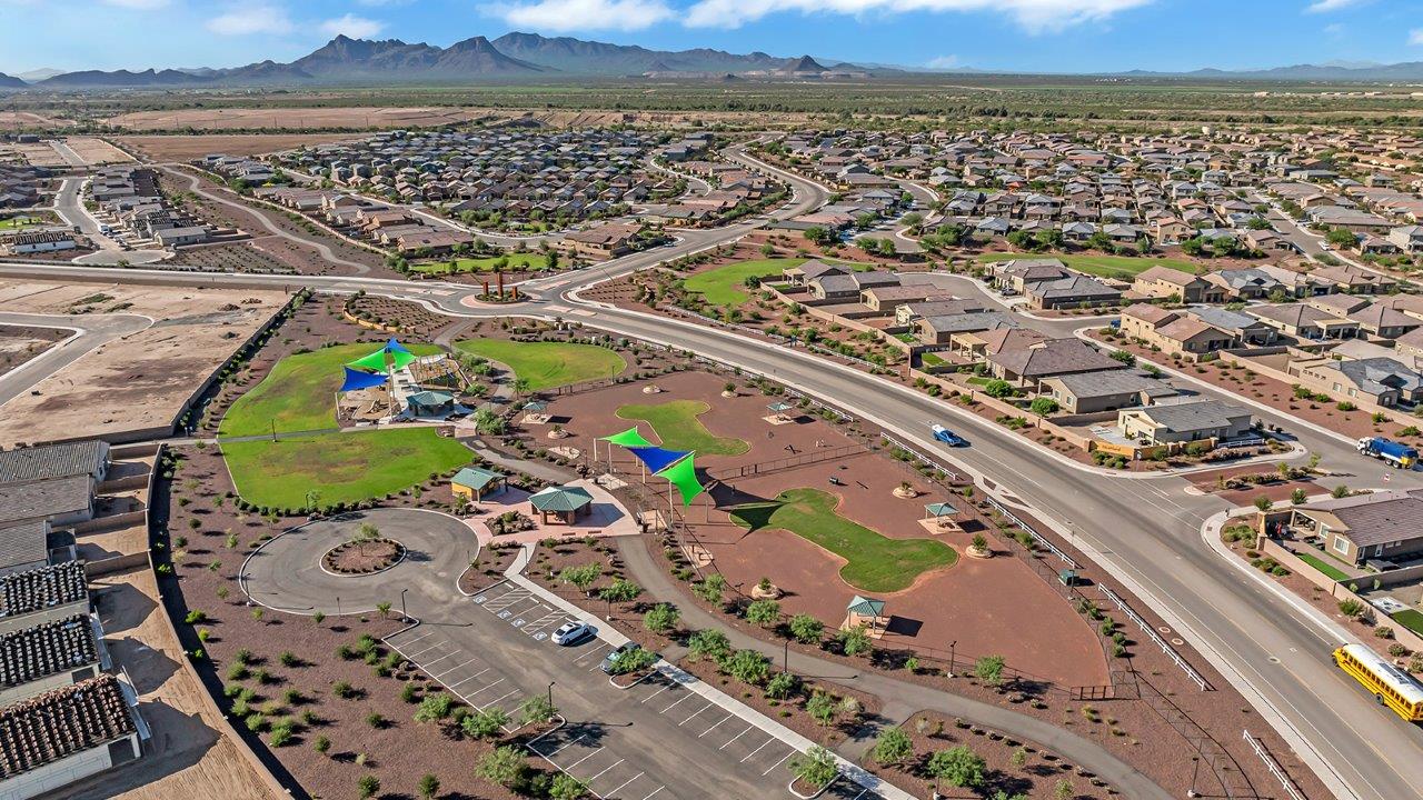 Welcome to The Madison within Coronet at Gladden Farms in Marana, Arizona – the largest new home in the community, offering an expansive 2,542 sq. ft. of living space designed to meet the needs of modern families.  As you step through the front porch, you’re welcomed into an entryway that opens up to the heart of the home. The main floor features a spacious great room that flows seamlessly into the dining area and kitchen, making it an ideal space for family gatherings and entertaining. The kitchen is a standout with its quartz countertops, large island, modern appliances, and a walk-in pantry.  On the main level, you'll also find a convenient bedroom and full bathroom, perfect for guests or as a private office space. The main floor’s design ensures both comfort and functionality, with direct access to the two-car garage and a covered patio that extends your living space outdoors.  Upstairs, the master suite offers a true retreat. The spacious bedroom leads to a large walk-in closet and an en-suite bathroom featuring dual vanities and a walk-in shower. The upper level also includes three additional bedrooms, a full bathroom, and a versatile loft area that can serve as a game room, home office, or second living area. A centrally located utility room adds convenience to everyday living.  Living at Coronet at Gladden Farms offers more than just a beautiful home. Residents enjoy exclusive amenities like a sparkling community pool, jacuzzi, fitness center, and clubhouse, along with access to 830 acres of green space, parks, playgrounds, and walking trails. This community is perfect for families who appreciate both comfort and outdoor adventure.  The Madison at Coronet at Gladden Farms is built with energy efficiency in mind, meeting DOE Zero Energy Ready Home standards. This means advanced features like tankless water heaters, energy-efficient LED lighting, and high-performance insulation are standard, ensuring lower utility costs and a reduced environmental footprint.