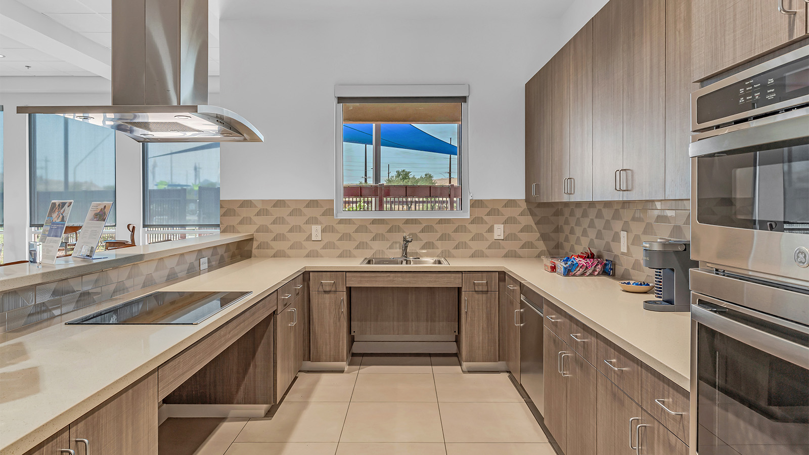 Welcome to The Aloe, a thoughtfully designed new floor plan within Coronet at Gladden Farms Community in Marana, Arizona. Offering 1,310 square feet of efficient and comfortable living space, The Aloe is ideal for those seeking a home that blends functionality, modern style, and everyday ease.  Upon entry, you’re welcomed into an open-concept layout that maximizes every square foot. The large great room serves as the heart of the home and flows seamlessly into the dining area and kitchen—perfect for both relaxing and entertaining. The kitchen is beautifully appointed with a central island, quartz countertops, Shaker-style cabinetry, and a dedicated pantry, creating a clean, modern aesthetic with ample storage and workspace.  The Aloe features three well-proportioned bedrooms designed for comfort and flexibility. The private primary suite is tucked away at the rear of the home and includes a walk-in closet and en-suite bathroom. Two additional bedrooms are located near the front of the home.  Designed with convenience in mind, the home includes a utility room near the kitchen, offering easy access to laundry and additional storage. A covered back patio extends the living space outdoors, providing the perfect setting to enjoy Gladden Farms beautiful weather and scenic surroundings.  Living at Coronet at Gladden Farms means enjoying a community that values both comfort and outdoor adventure. With access to 830 acres of green space, parks, playgrounds, and exclusive amenities like a sparkling pool, fitness center, and clubhouse, this community is perfect for families and active lifestyles.