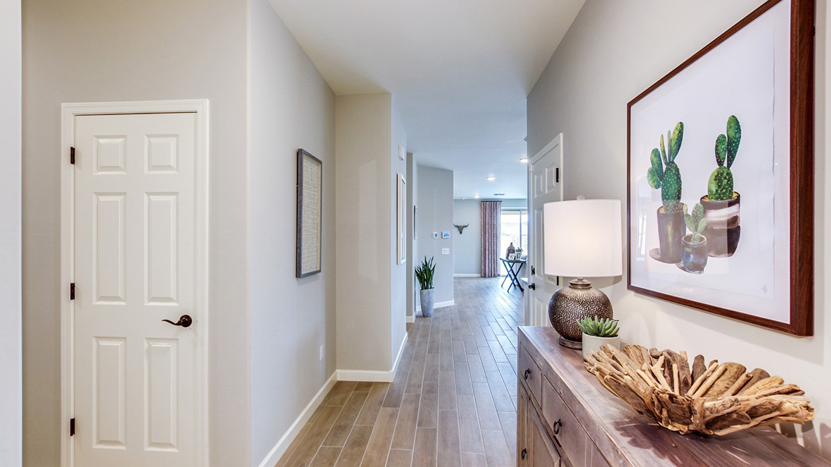 Welcome to The Citrine, a spacious single-story new home located in the Sycamore Vista. With 2,577 square feet of well-planned living space, this home offers four bedrooms, three bathrooms, and a dedicated study, making it ideal for families who value both space and convenience.  As you enter through the inviting covered porch, you’re greeted by a bright and airy entryway that flows into the heart of the home. The expansive great room, dining area, and kitchen are thoughtfully connected, creating an ideal space for entertaining or enjoying time with family. The kitchen features a large island, quartz countertops, and Shaker-style cabinetry. A spacious pantry and modern stainless-steel appliances ensure your kitchen is both functional and stylish.  The Citrine’s layout includes a generously sized primary bedroom, carefully positioned for privacy at the rear of the home. This room features a large walk-in closet and an en-suite bathroom with luxurious super shower. The additional three bedrooms are well-sized and located in separate areas of the home, ensuring privacy and easy access to two more full bathrooms.  One of the highlights of The Citrine is its versatile study, which can be used as a home office, media room, or extra bedroom for guests. The large laundry room, conveniently situated near the bedrooms, adds to the home’s practicality.  The covered patio, accessible from the great room, offers a perfect spot for outdoor living, where you can enjoy Arizona’s beautiful weather throughout the year. Whether you’re hosting a barbecue or simply relaxing, this outdoor space enhances the home’s appeal.  Designed with energy efficiency and modern living in mind, The Citrine includes smart home technology ensuring comfort and sustainability. Large windows throughout the home allow natural light to brighten every corner.  The Citrine combines style, comfort, and practicality, making it a perfect place to call home in one of Vails’s most sought-after communities.