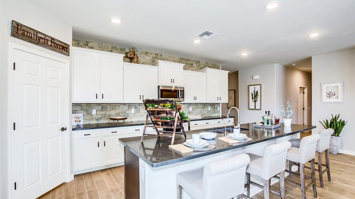 Welcome to The Citrine, a spacious single-story new home located in the Sycamore Vista. With 2,577 square feet of well-planned living space, this home offers four bedrooms, three bathrooms, and a dedicated study, making it ideal for families who value both space and convenience.  As you enter through the inviting covered porch, you’re greeted by a bright and airy entryway that flows into the heart of the home. The expansive great room, dining area, and kitchen are thoughtfully connected, creating an ideal space for entertaining or enjoying time with family. The kitchen features a large island, quartz countertops, and Shaker-style cabinetry. A spacious pantry and modern stainless-steel appliances ensure your kitchen is both functional and stylish.  The Citrine’s layout includes a generously sized primary bedroom, carefully positioned for privacy at the rear of the home. This room features a large walk-in closet and an en-suite bathroom with luxurious super shower. The additional three bedrooms are well-sized and located in separate areas of the home, ensuring privacy and easy access to two more full bathrooms.  One of the highlights of The Citrine is its versatile study, which can be used as a home office, media room, or extra bedroom for guests. The large laundry room, conveniently situated near the bedrooms, adds to the home’s practicality.  The covered patio, accessible from the great room, offers a perfect spot for outdoor living, where you can enjoy Arizona’s beautiful weather throughout the year. Whether you’re hosting a barbecue or simply relaxing, this outdoor space enhances the home’s appeal.  Designed with energy efficiency and modern living in mind, The Citrine includes smart home technology ensuring comfort and sustainability. Large windows throughout the home allow natural light to brighten every corner.  The Citrine combines style, comfort, and practicality, making it a perfect place to call home in one of Vails’s most sought-after communities.