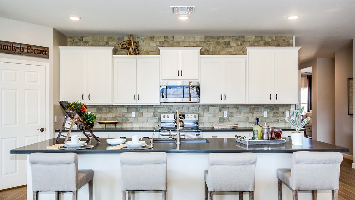 Welcome to The Citrine, a spacious single-story new home located in the Sycamore Vista. With 2,577 square feet of well-planned living space, this home offers four bedrooms, three bathrooms, and a dedicated study, making it ideal for families who value both space and convenience.  As you enter through the inviting covered porch, you’re greeted by a bright and airy entryway that flows into the heart of the home. The expansive great room, dining area, and kitchen are thoughtfully connected, creating an ideal space for entertaining or enjoying time with family. The kitchen features a large island, quartz countertops, and Shaker-style cabinetry. A spacious pantry and modern stainless-steel appliances ensure your kitchen is both functional and stylish.  The Citrine’s layout includes a generously sized primary bedroom, carefully positioned for privacy at the rear of the home. This room features a large walk-in closet and an en-suite bathroom with luxurious super shower. The additional three bedrooms are well-sized and located in separate areas of the home, ensuring privacy and easy access to two more full bathrooms.  One of the highlights of The Citrine is its versatile study, which can be used as a home office, media room, or extra bedroom for guests. The large laundry room, conveniently situated near the bedrooms, adds to the home’s practicality.  The covered patio, accessible from the great room, offers a perfect spot for outdoor living, where you can enjoy Arizona’s beautiful weather throughout the year. Whether you’re hosting a barbecue or simply relaxing, this outdoor space enhances the home’s appeal.  Designed with energy efficiency and modern living in mind, The Citrine includes smart home technology ensuring comfort and sustainability. Large windows throughout the home allow natural light to brighten every corner.  The Citrine combines style, comfort, and practicality, making it a perfect place to call home in one of Vails’s most sought-after communities.